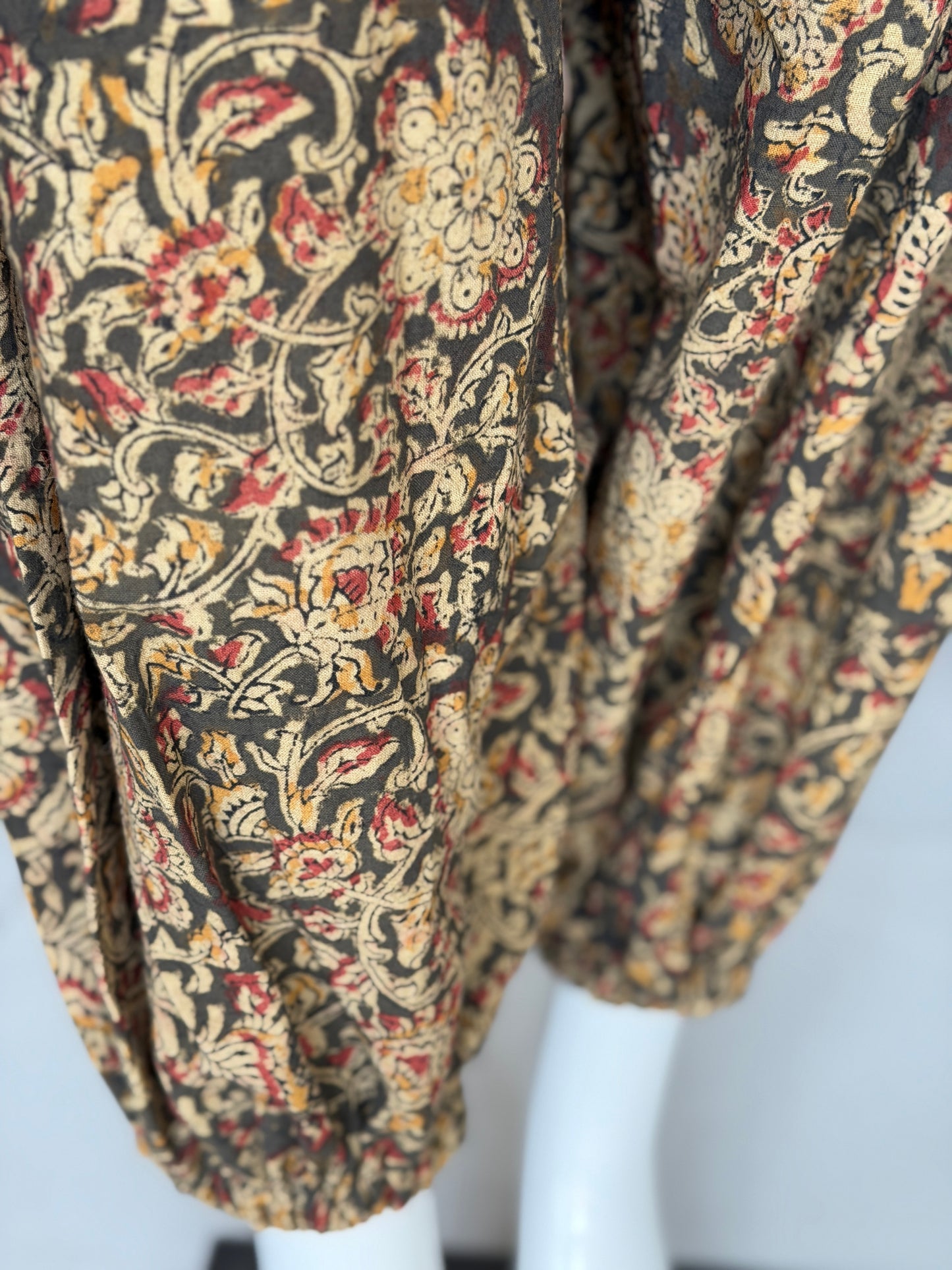 Olive green Kalamkari hand block printed cotton harem pants for women with elastic hem