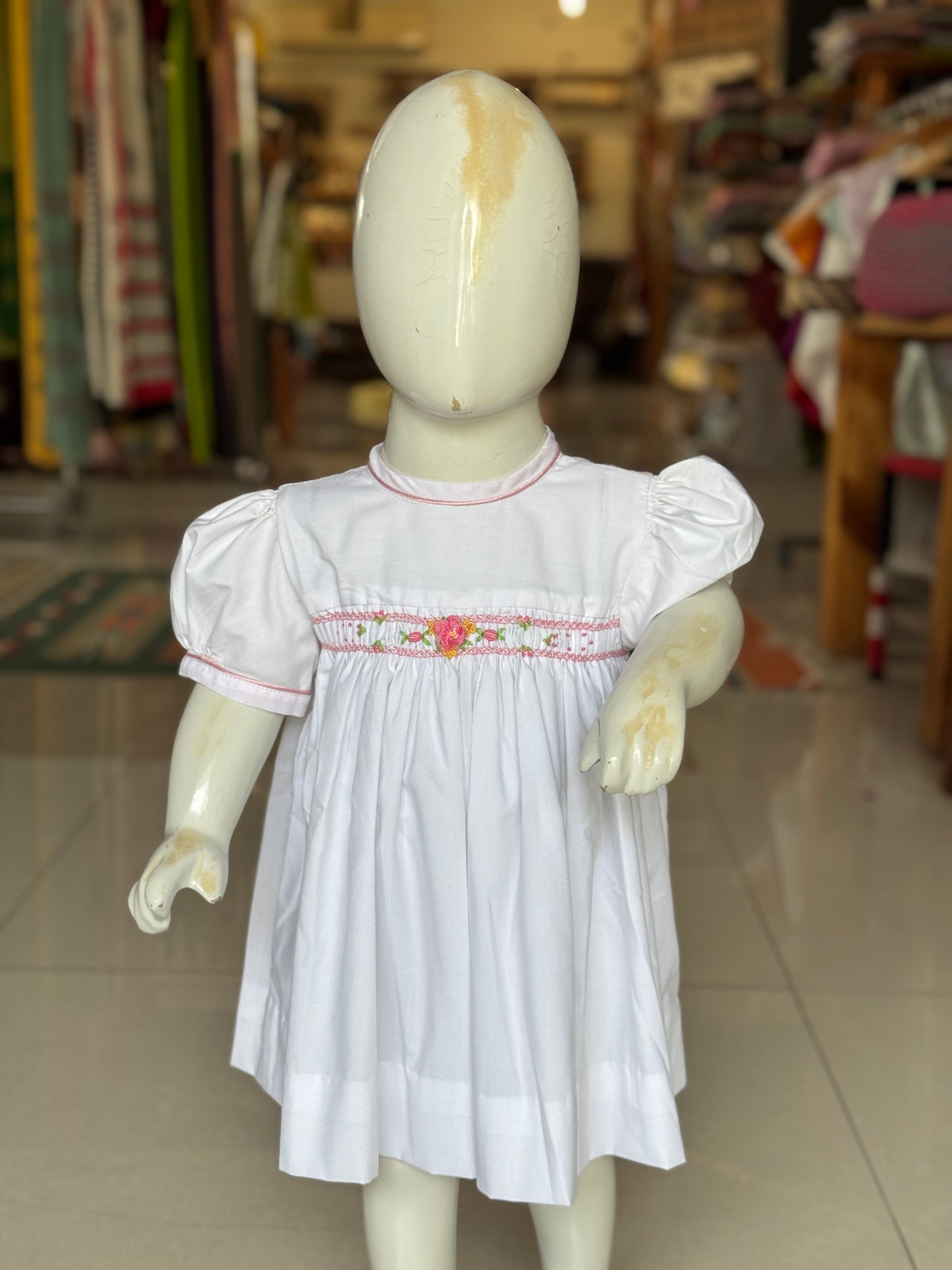 White hand embroidered smocking cotton frock for girls with piping at neck line
