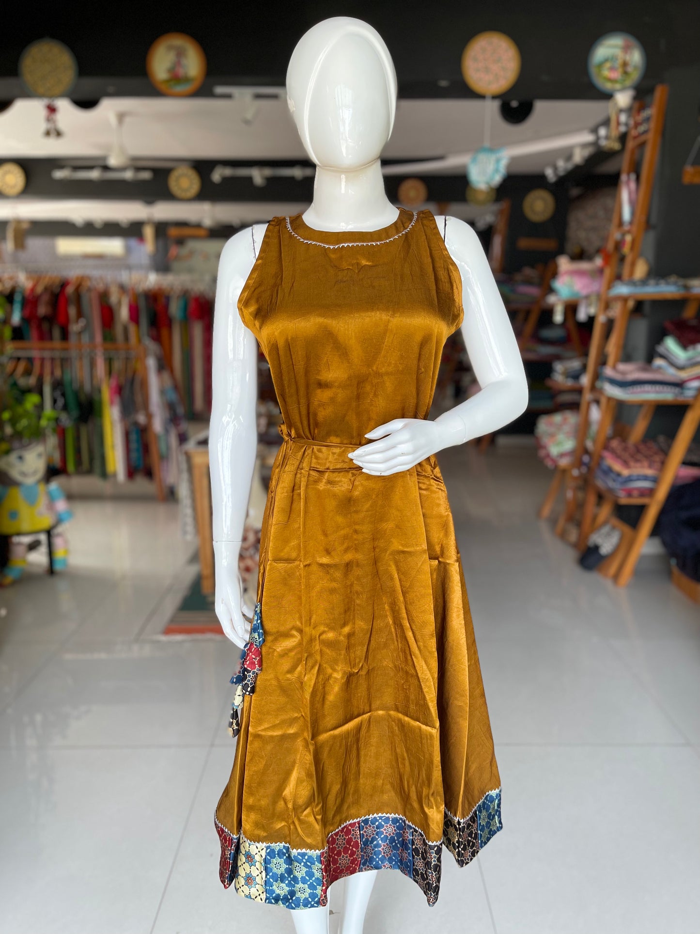 Mashru plain sleeveless dress with Ajrakh hand block printed patch border and tassles belt