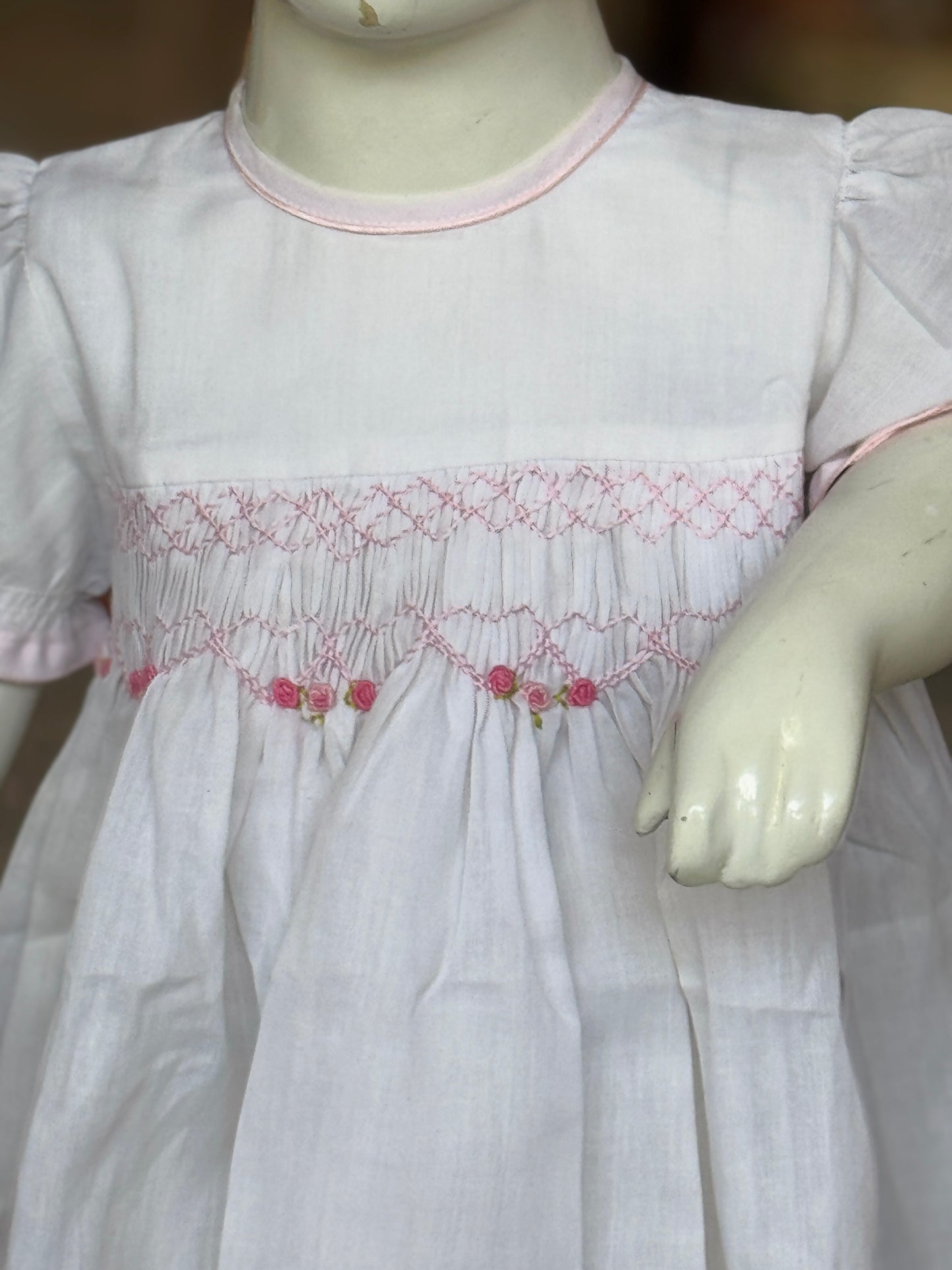 White hand embroidered smocking cotton frock for little girls with pink trims