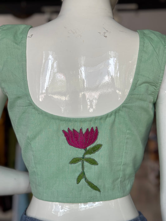 Green cotton sleeveless handloom blouse with hand embroidered flower on the back