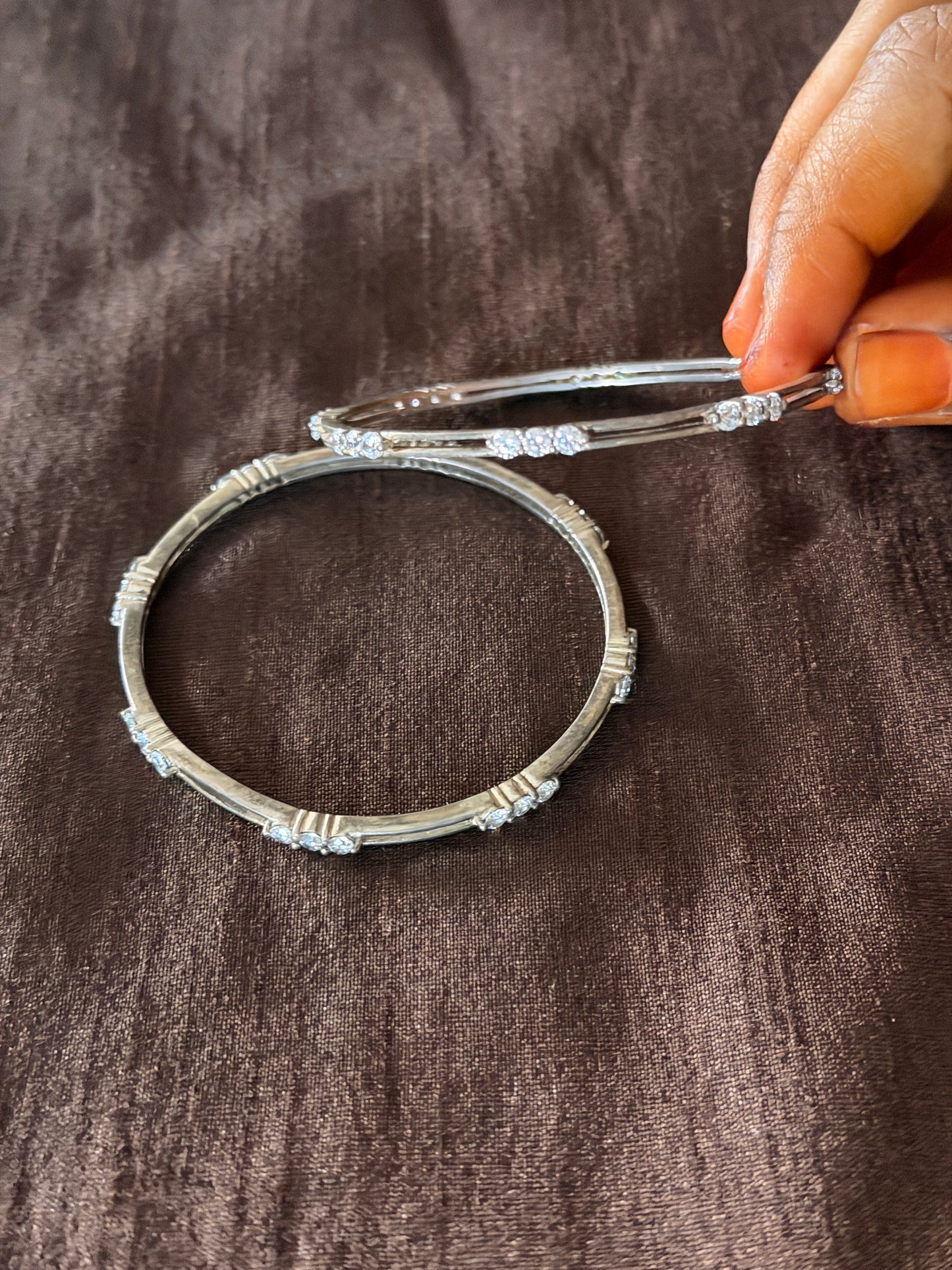 Silver bangles pair with white stone between 2 lines