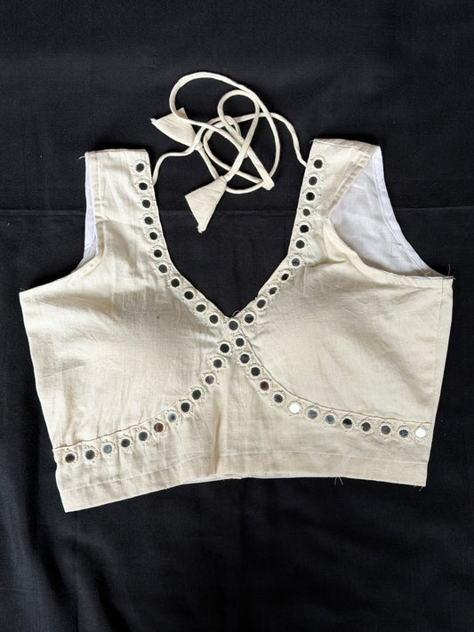 Off white handloom kala cotton sleeveless blouse with mirror work along the bust line