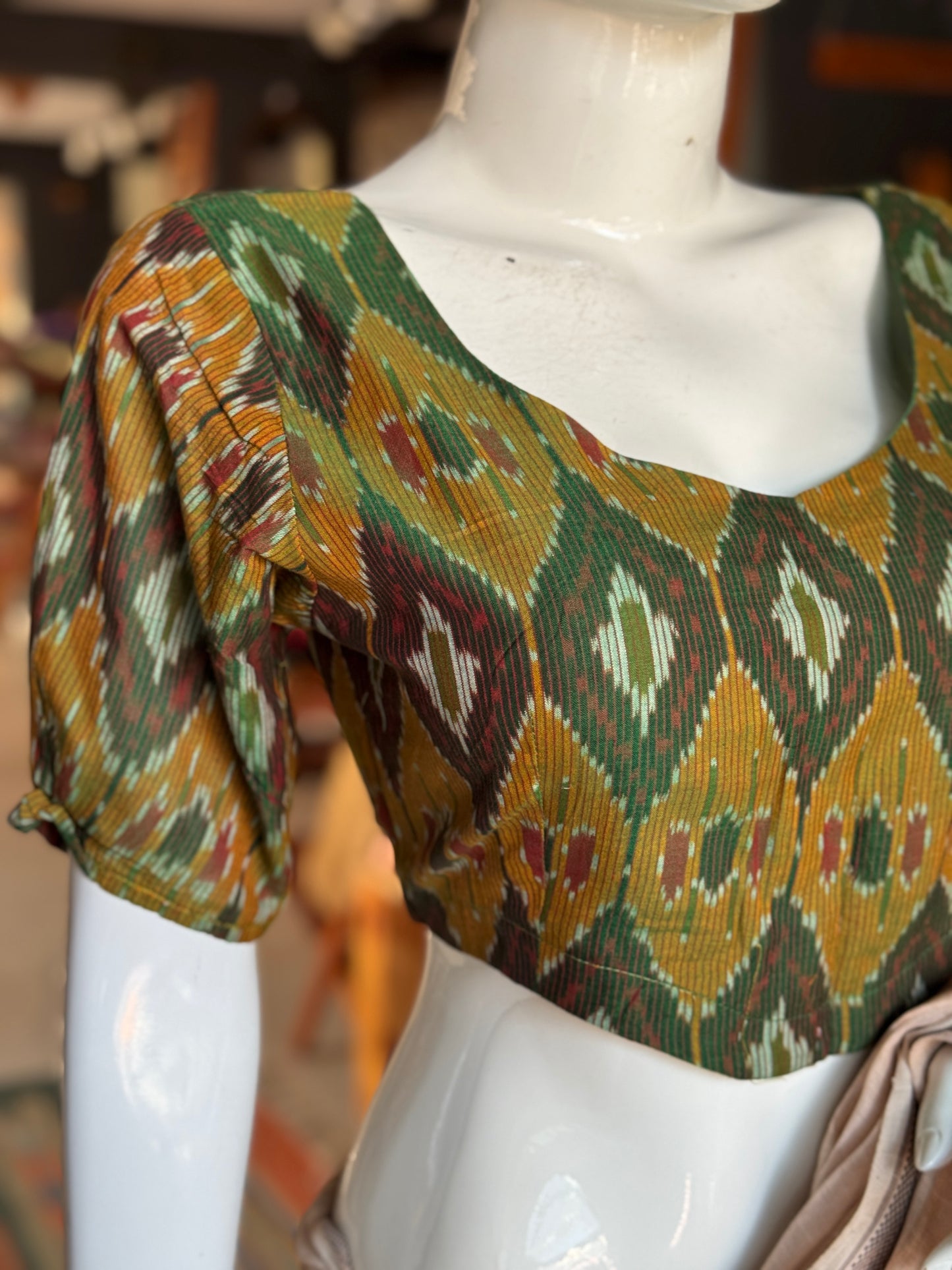 Dark green Ikat cotton blouse with curved waist line