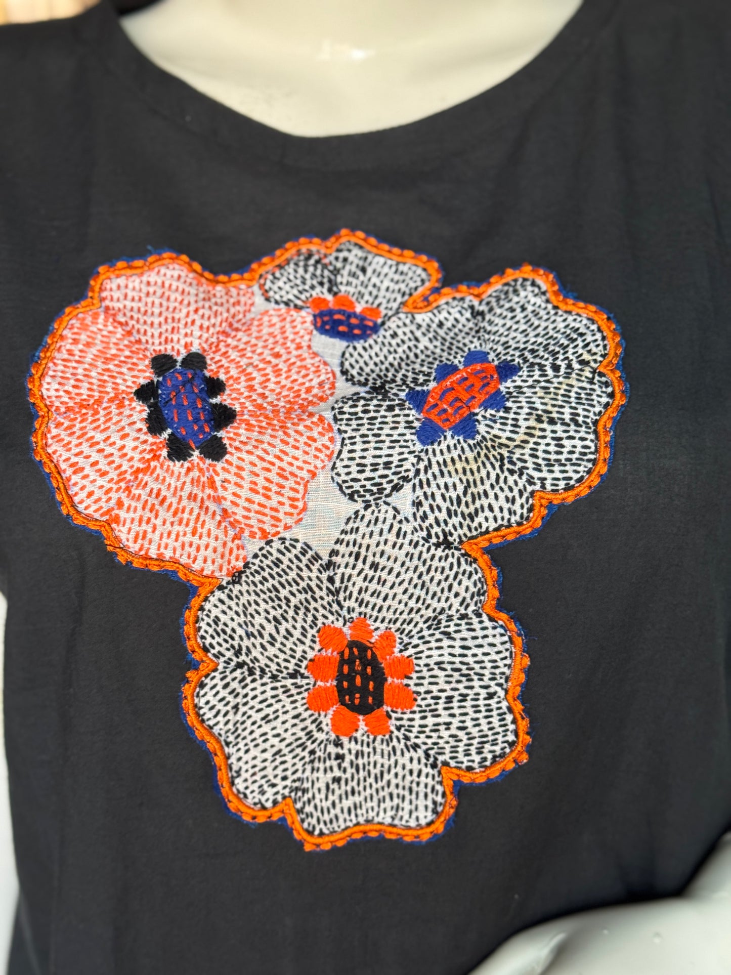 Black cotton top with hand embroidery on the front