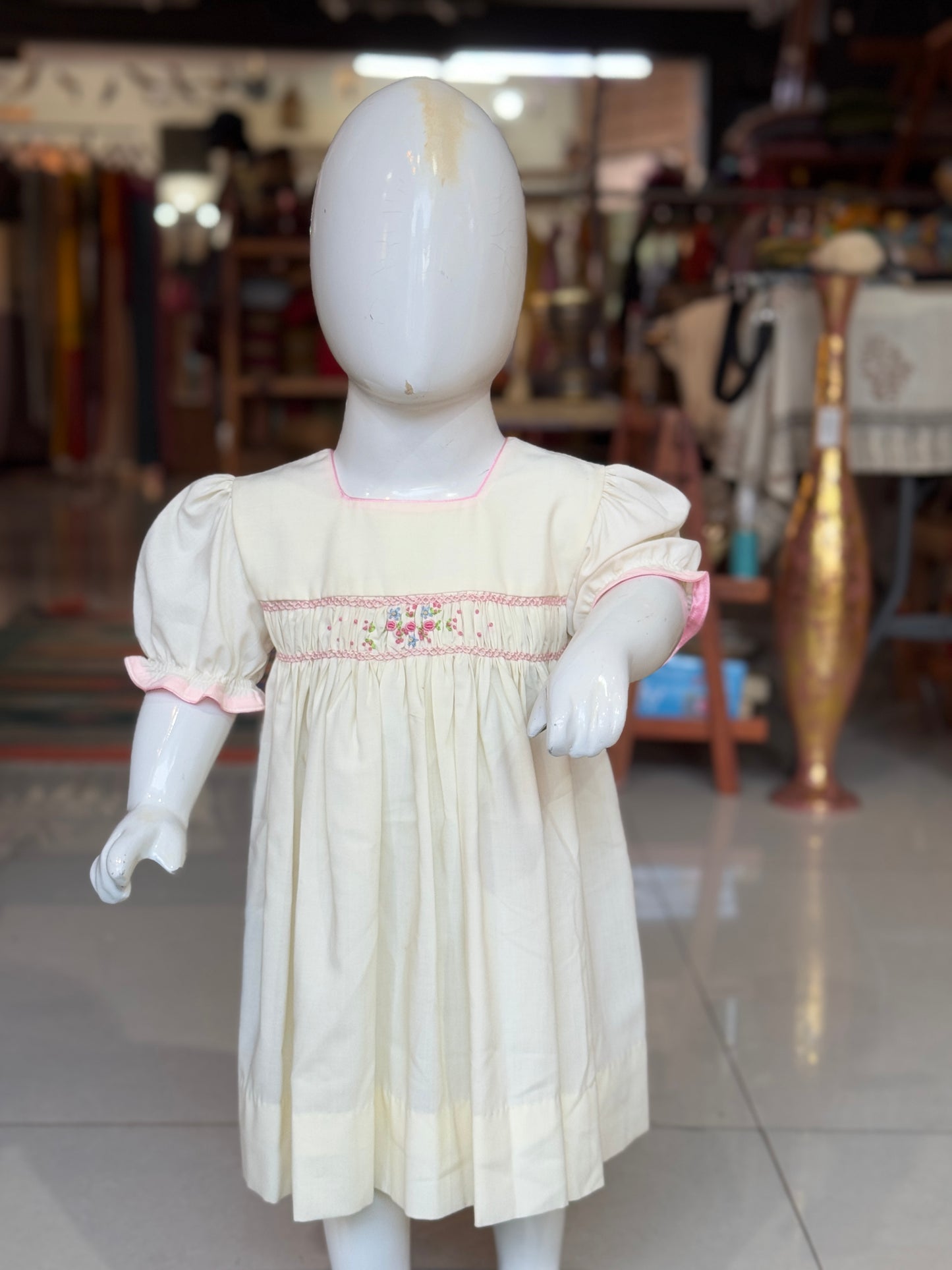 Cream smocking square neck cotton frock with hand embroidery and pink trims