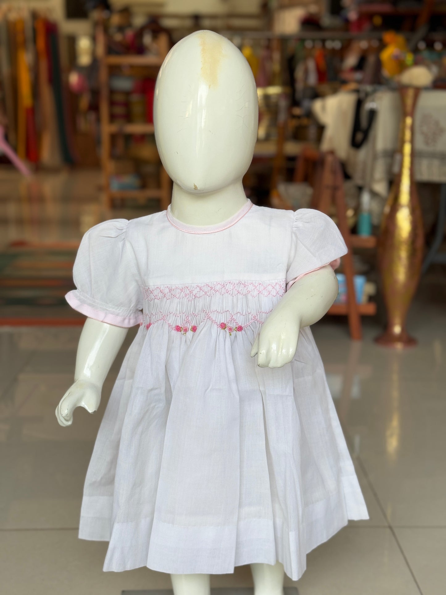 White hand embroidered smocking cotton frock for little girls with pink trims