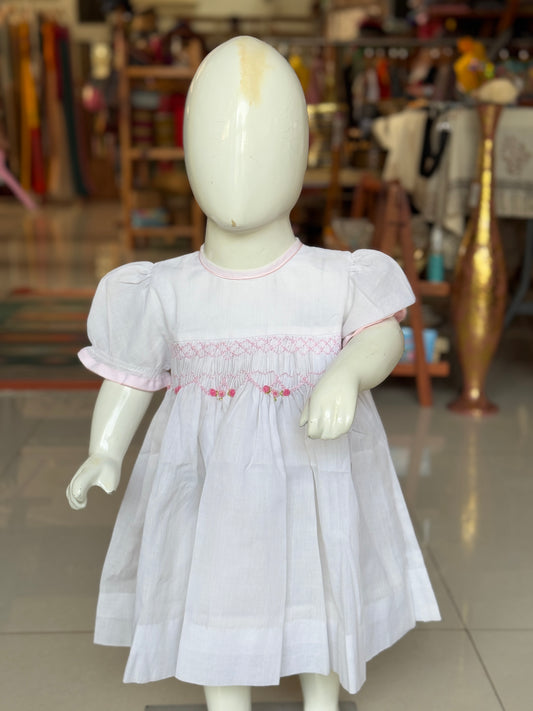 White hand embroidered smocking cotton frock for little girls with pink trims