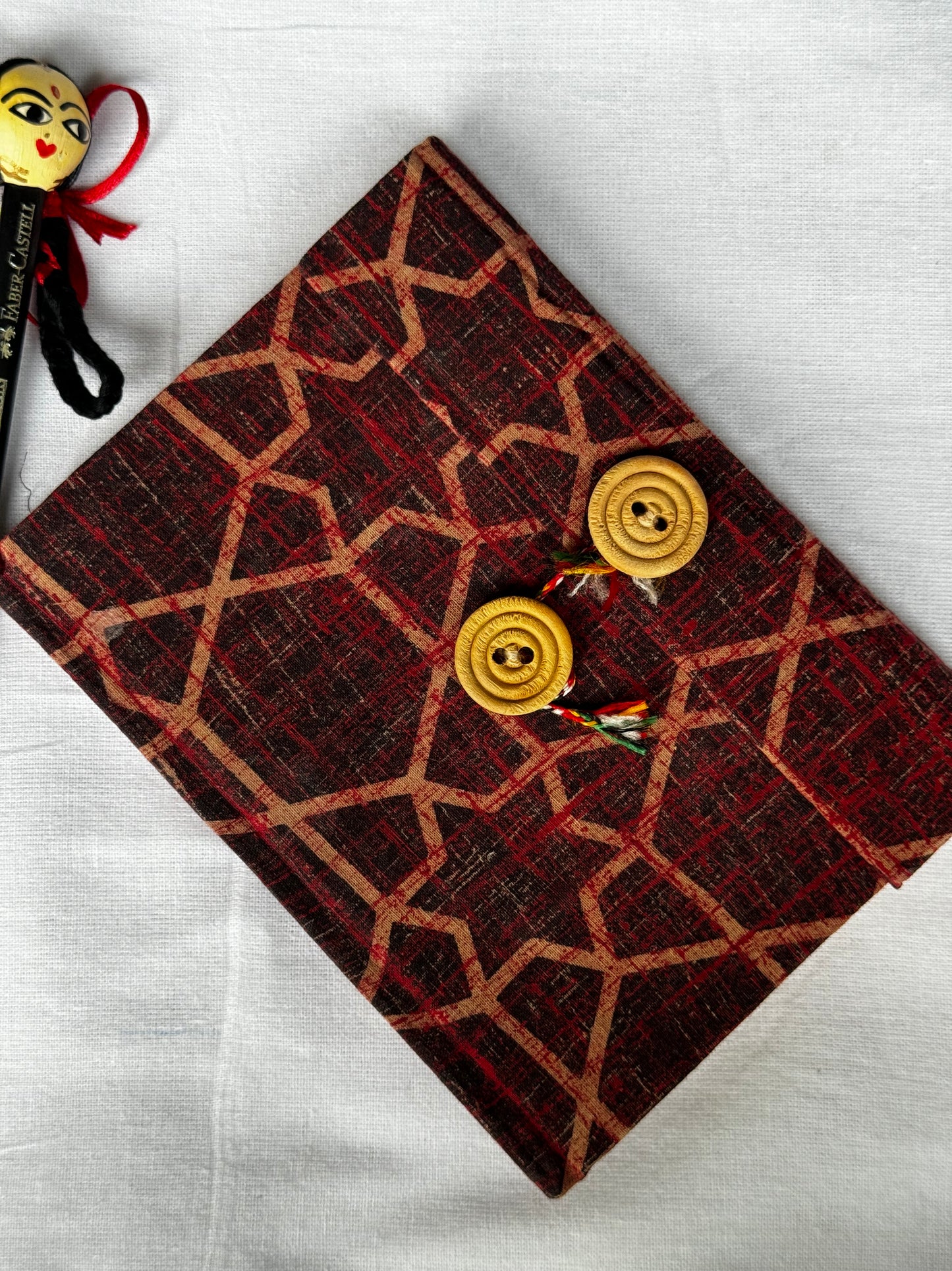 Pocket notebook with fabric cover with button and thread closure