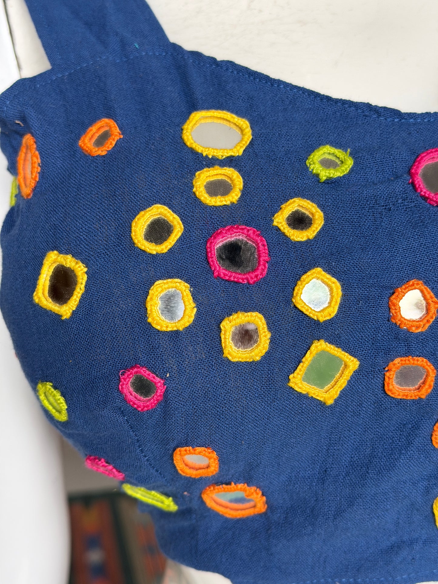 Navy blue kala cotton sleeveless blouse with all over colorful mirror work on front and back with adjustable width back