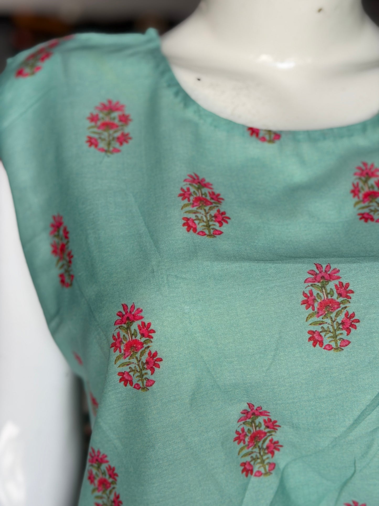 Green floral print top with asymmetric pleats on shoulder