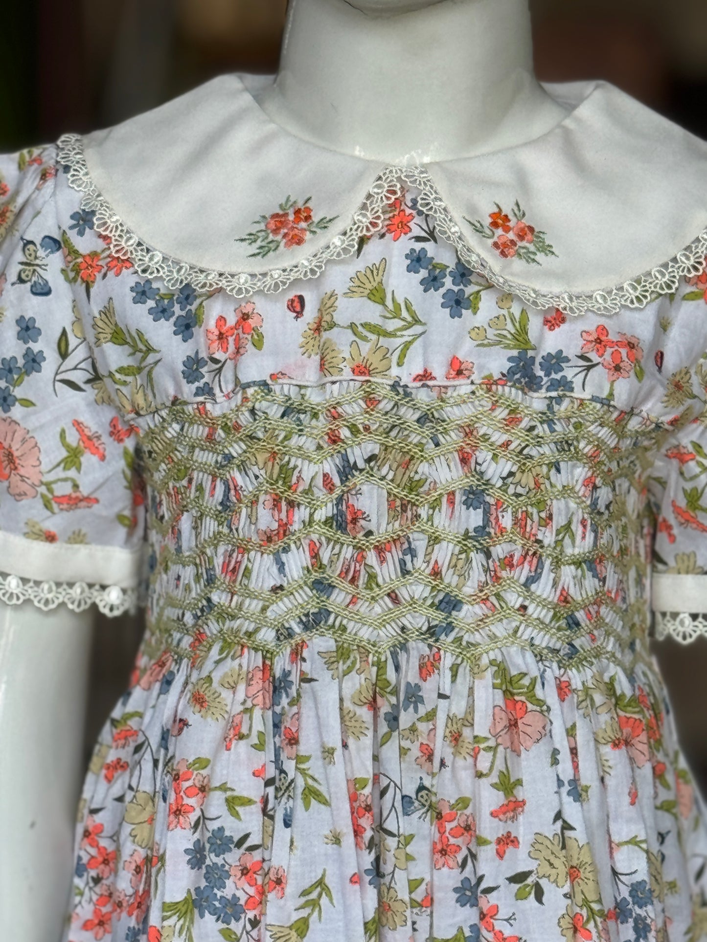 White floral print hand embroidered smocking cotton frock for girls with collar and lace trims
