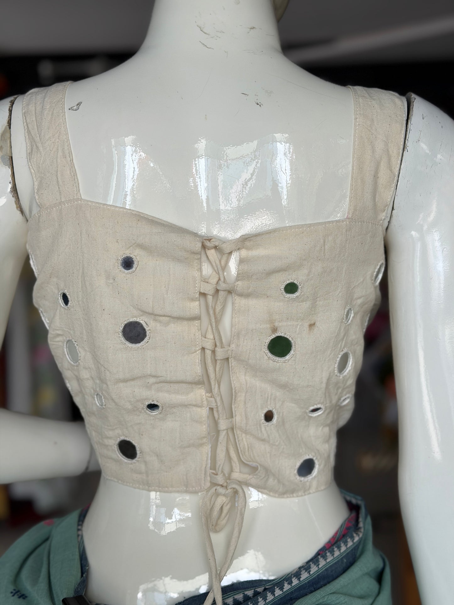 Off white kala cotton sleeveless blouse with all over colorful mirror work on front and back - adjustable back width