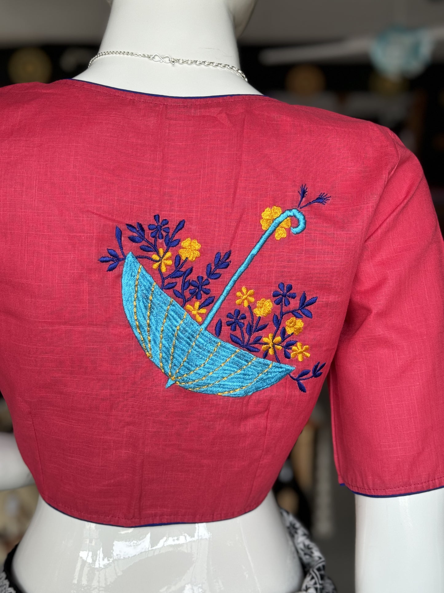 Pink cotton blouse with inverted umbrella embroidery at the back