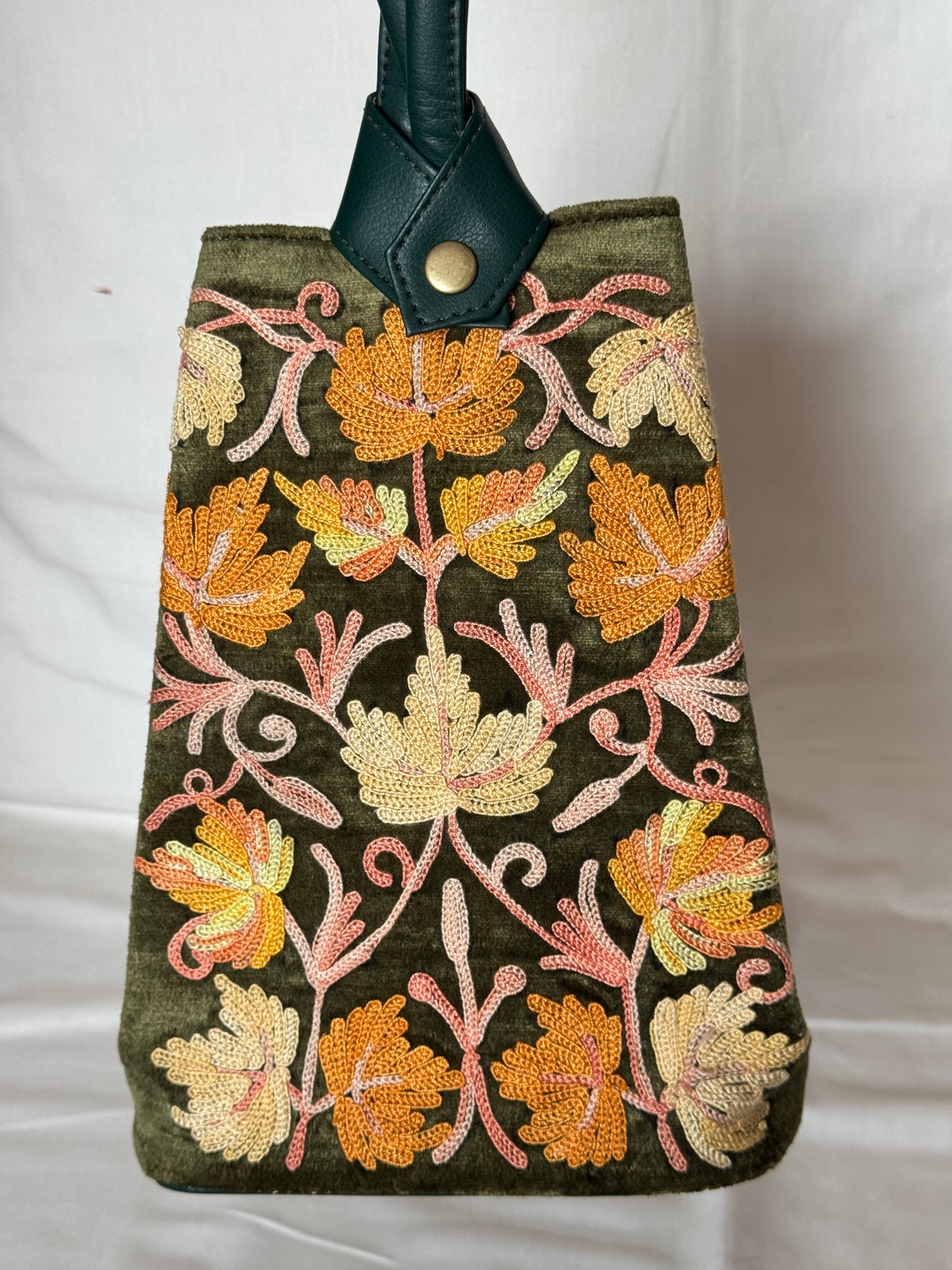 Potli bags with Kashmiri floral Aari embroidery - interesting twist around handle button closure