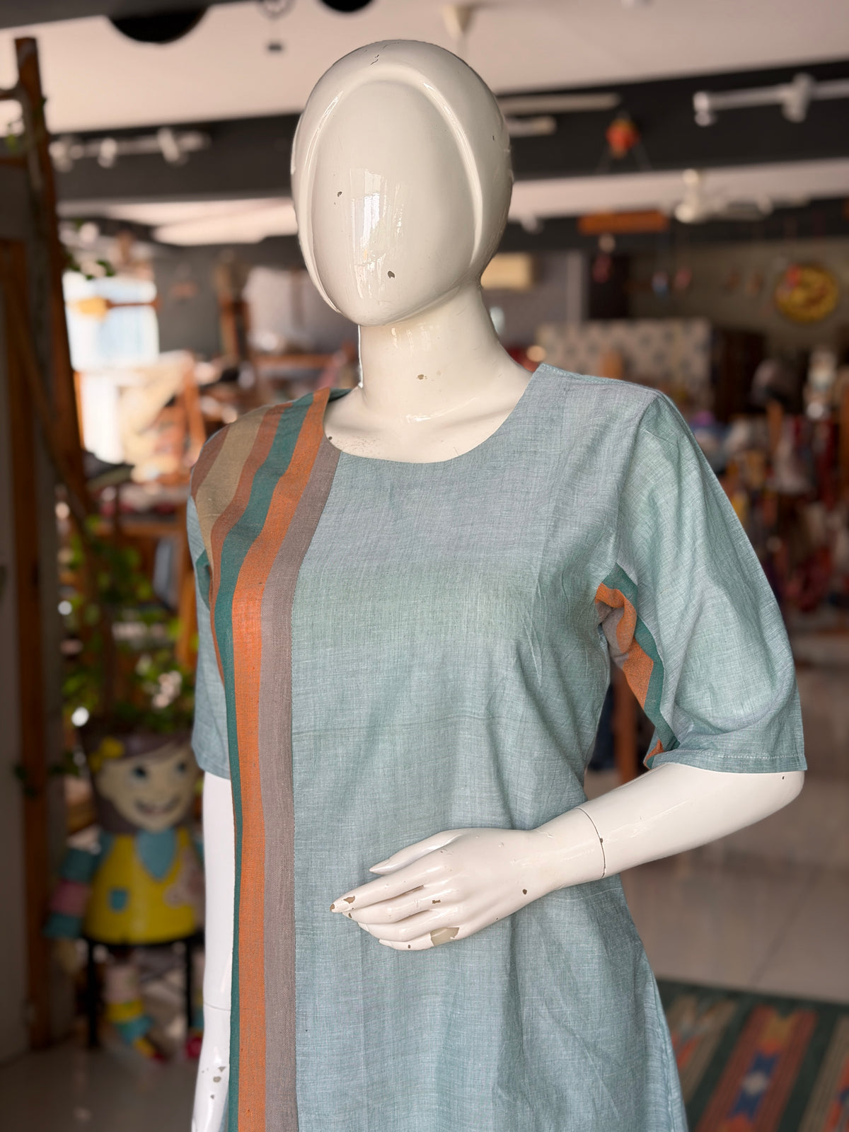 Green handloom cotton dress with hand woven kala cotton stripes on one side