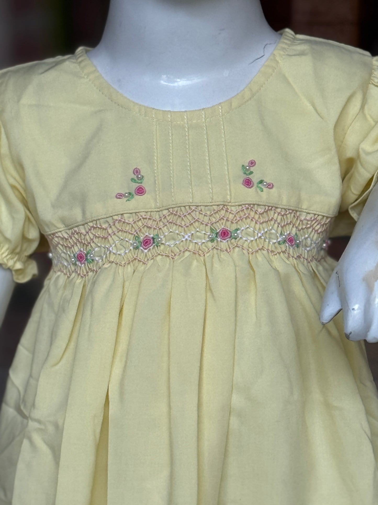 Light yellow hand embroidered smocking cotton frock for girls with vertical pintucks at neck