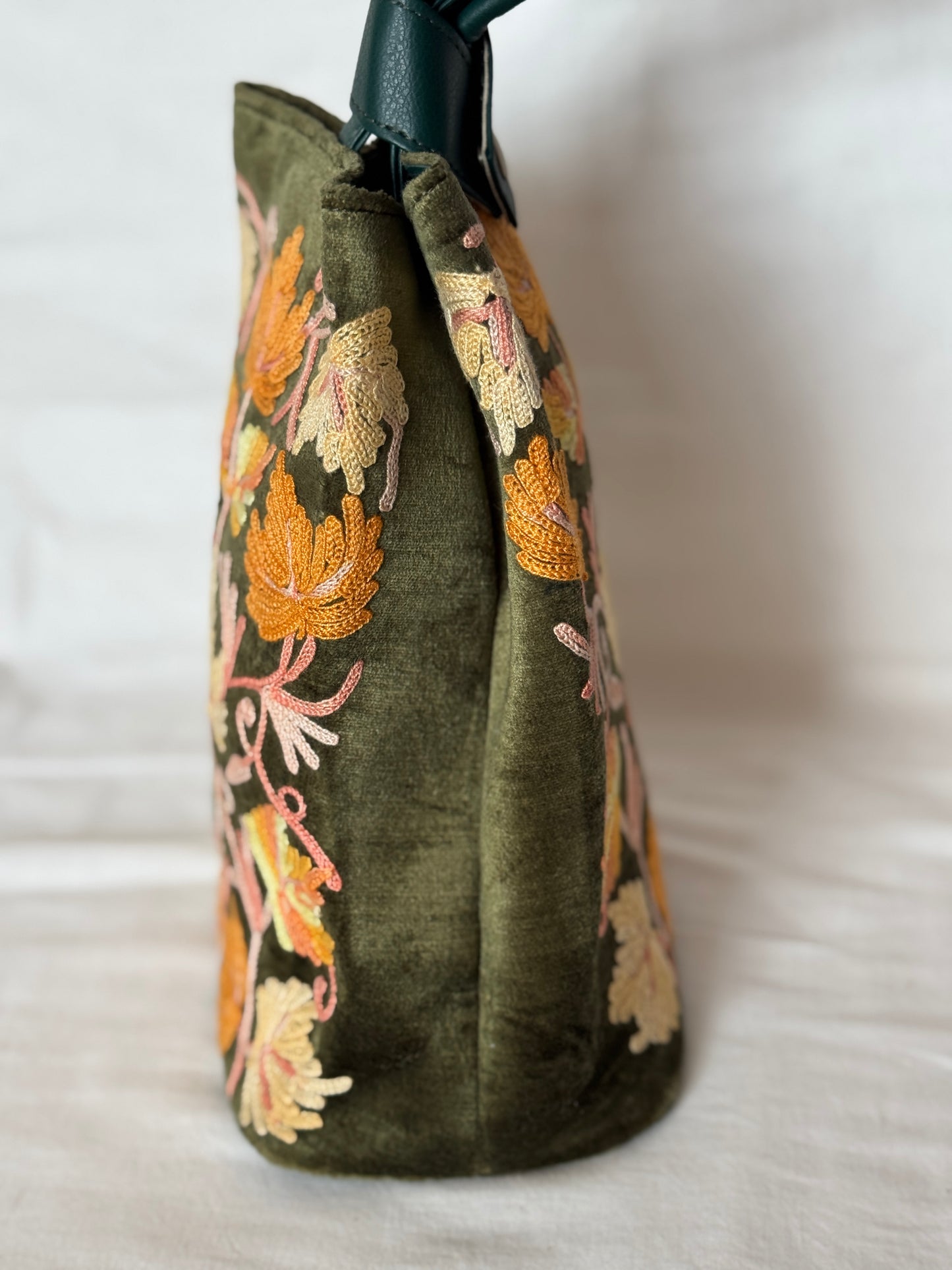 Potli bags with Kashmiri floral Aari embroidery - interesting twist around handle button closure