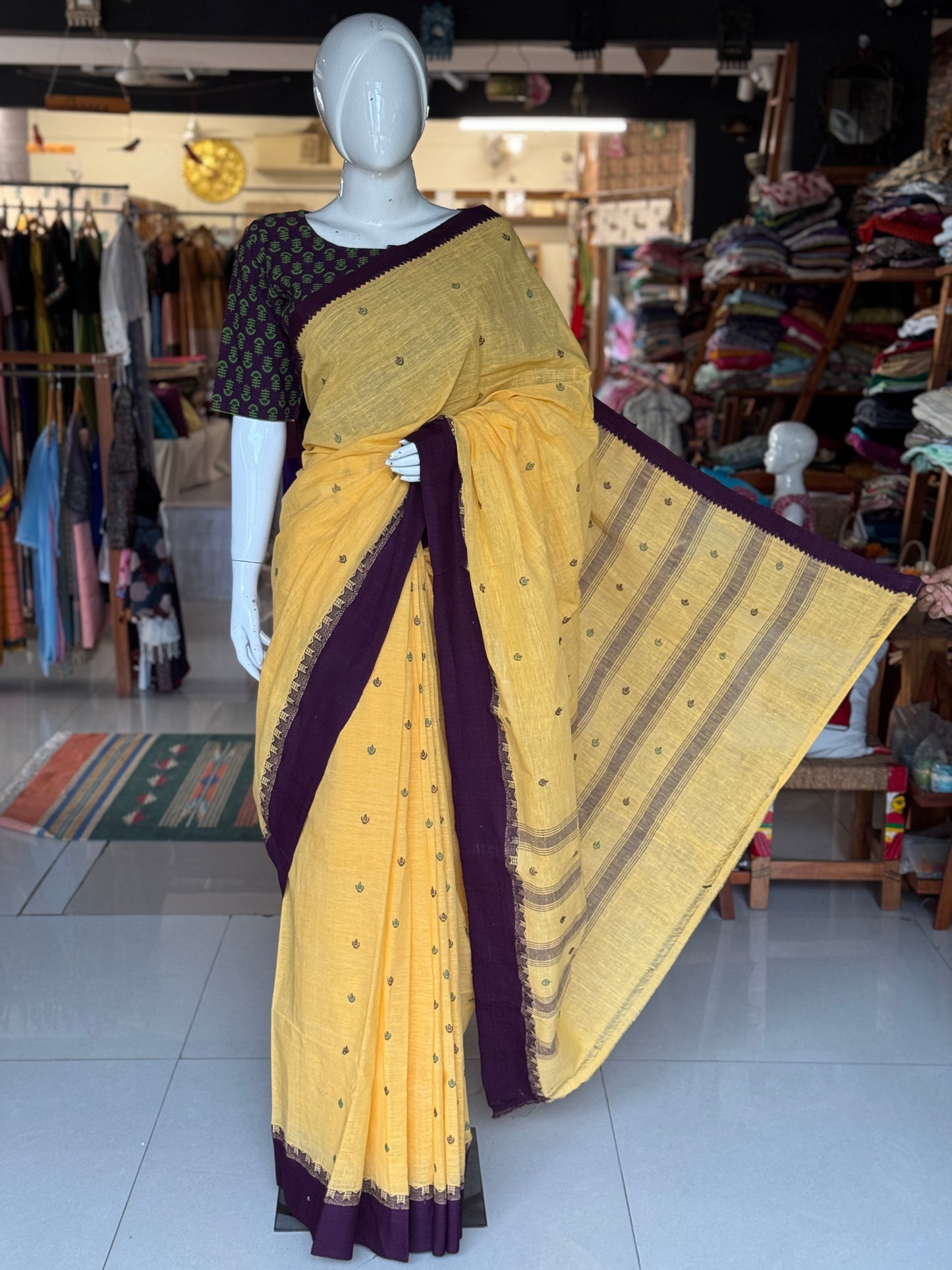 Yellow coarse textured handloom cotton saree with small butis and purple Kuppadam border