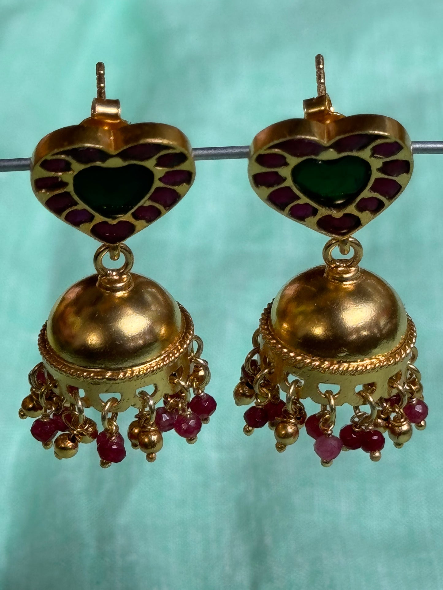 Pink and green kundans heart shaped studs with gold polish plain jhumka earrings in 92.5 sterling silver