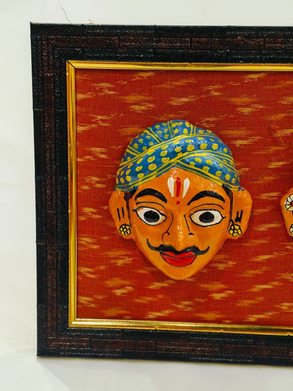 Cheriyal man and woman handcrafted masks pair on ikat background wall frame