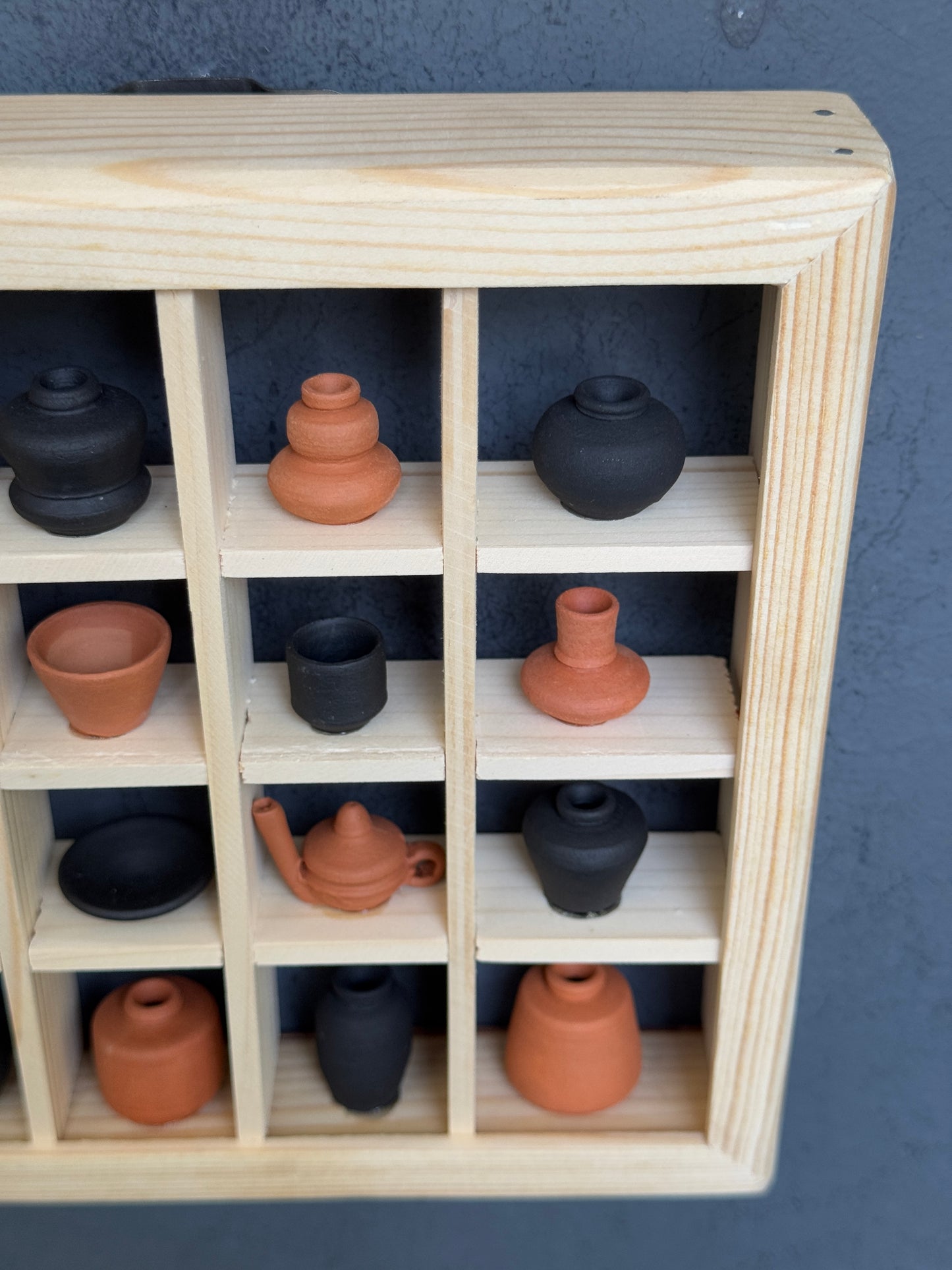 Miniature handcrafted clay pots in a wooden shelf - 6 x 6 inch frame size