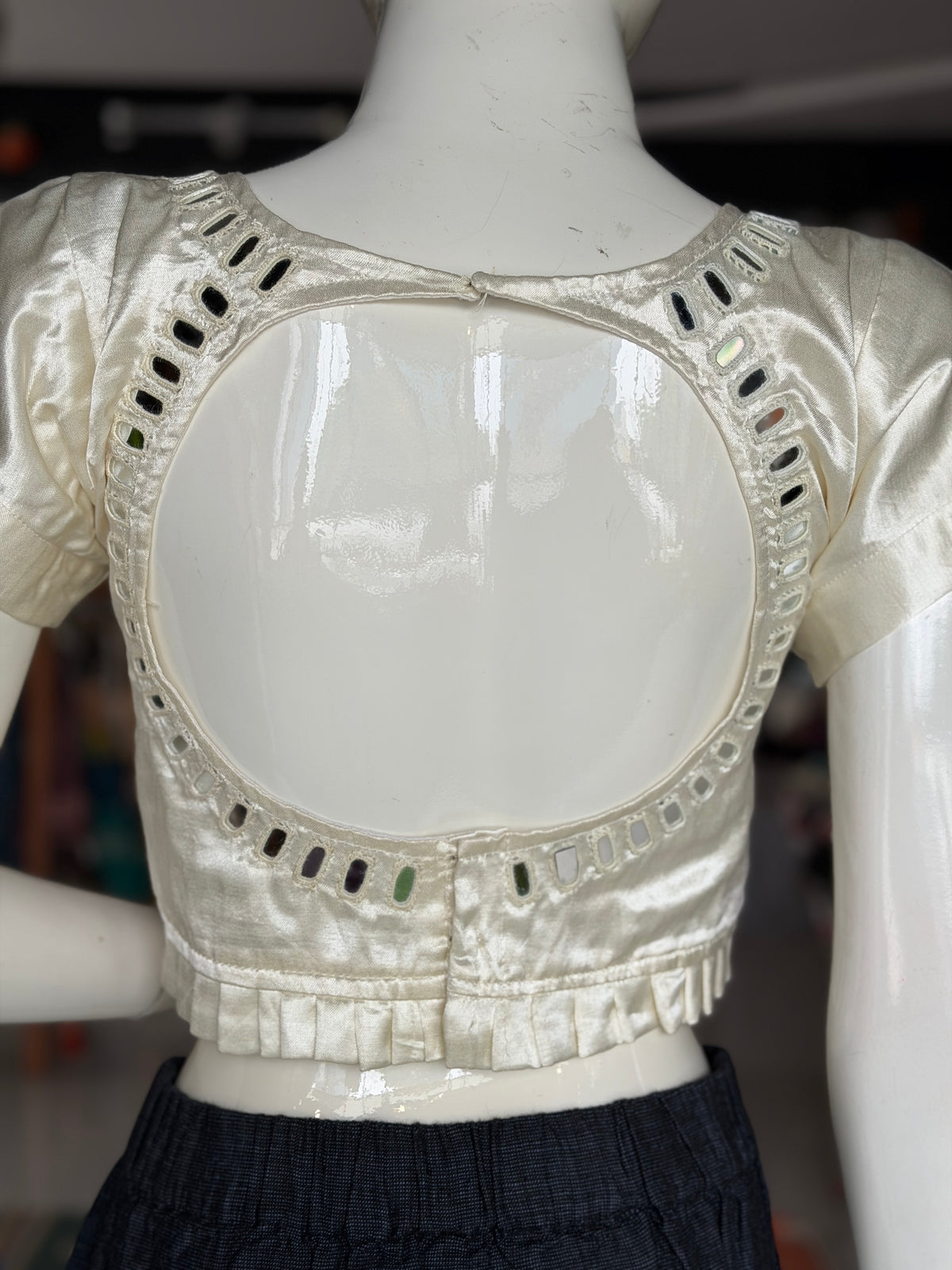 Off white mashru plain blouse with mirror work on front and back; pleated waist line