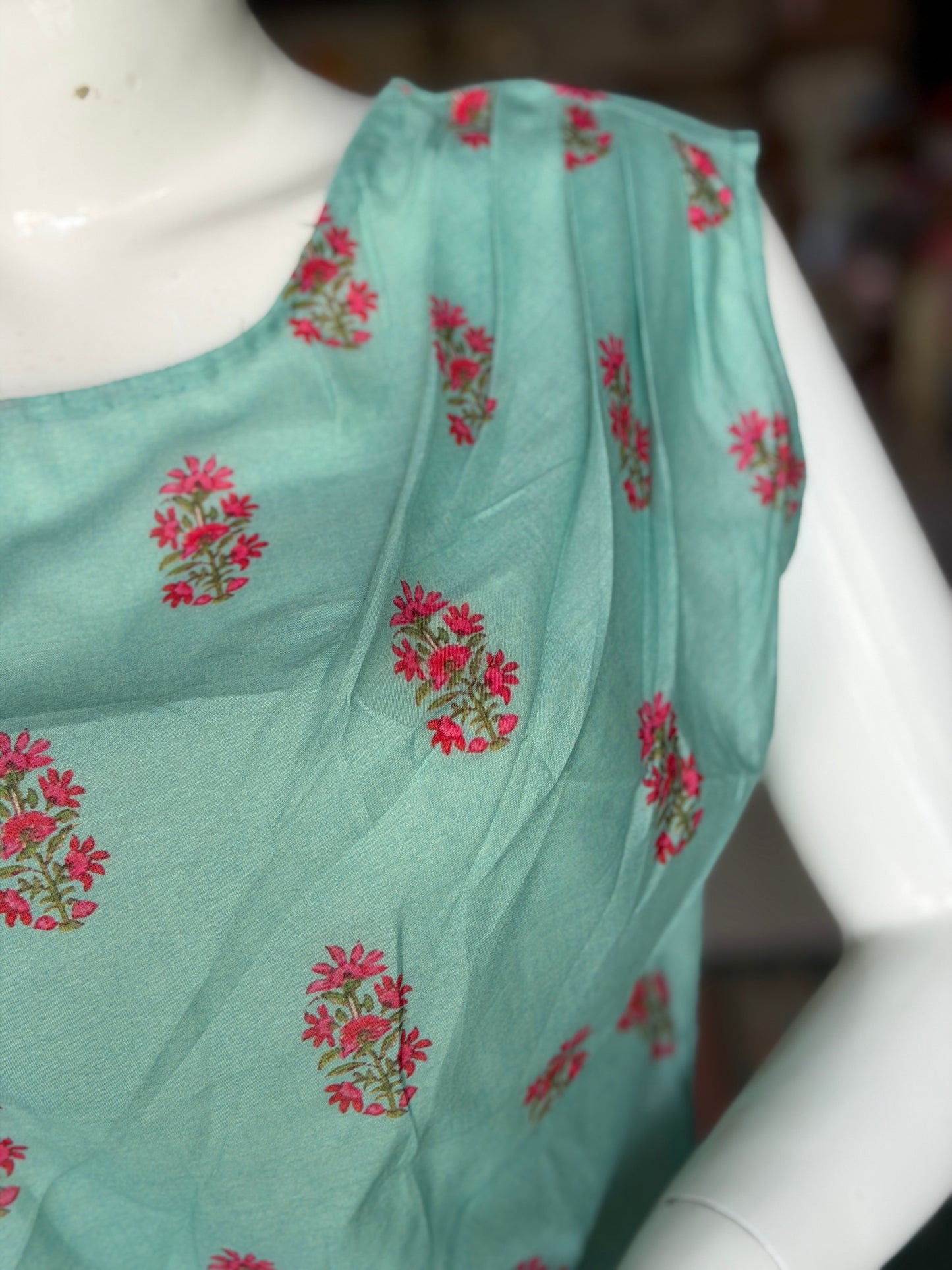 Green floral print top with asymmetric pleats on shoulder