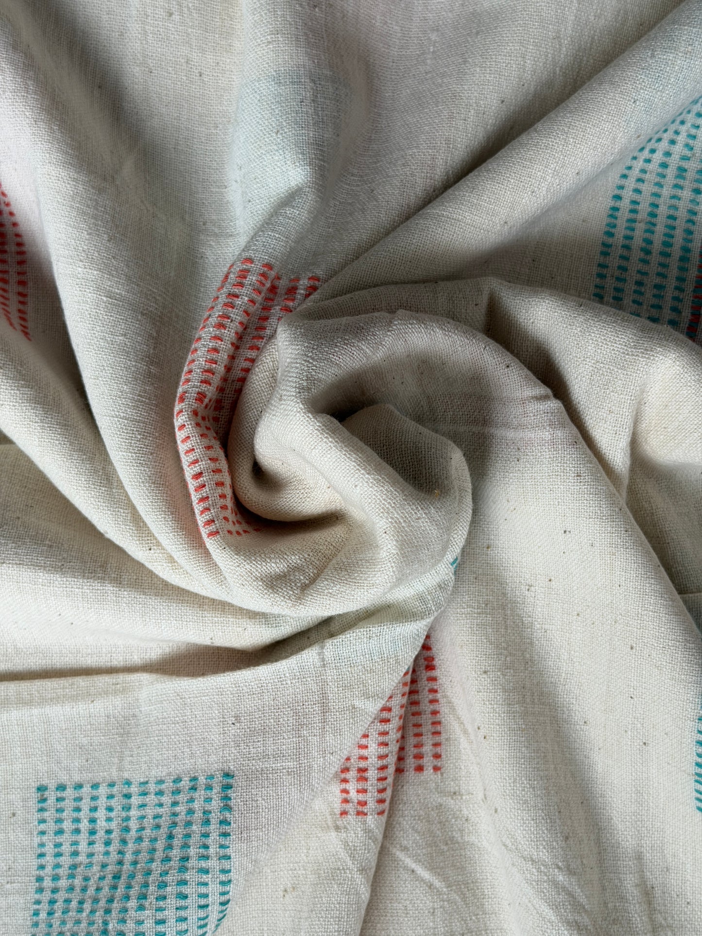 Off white cotton hand spun, hand woven fabric with orange and blue woven rectangles
