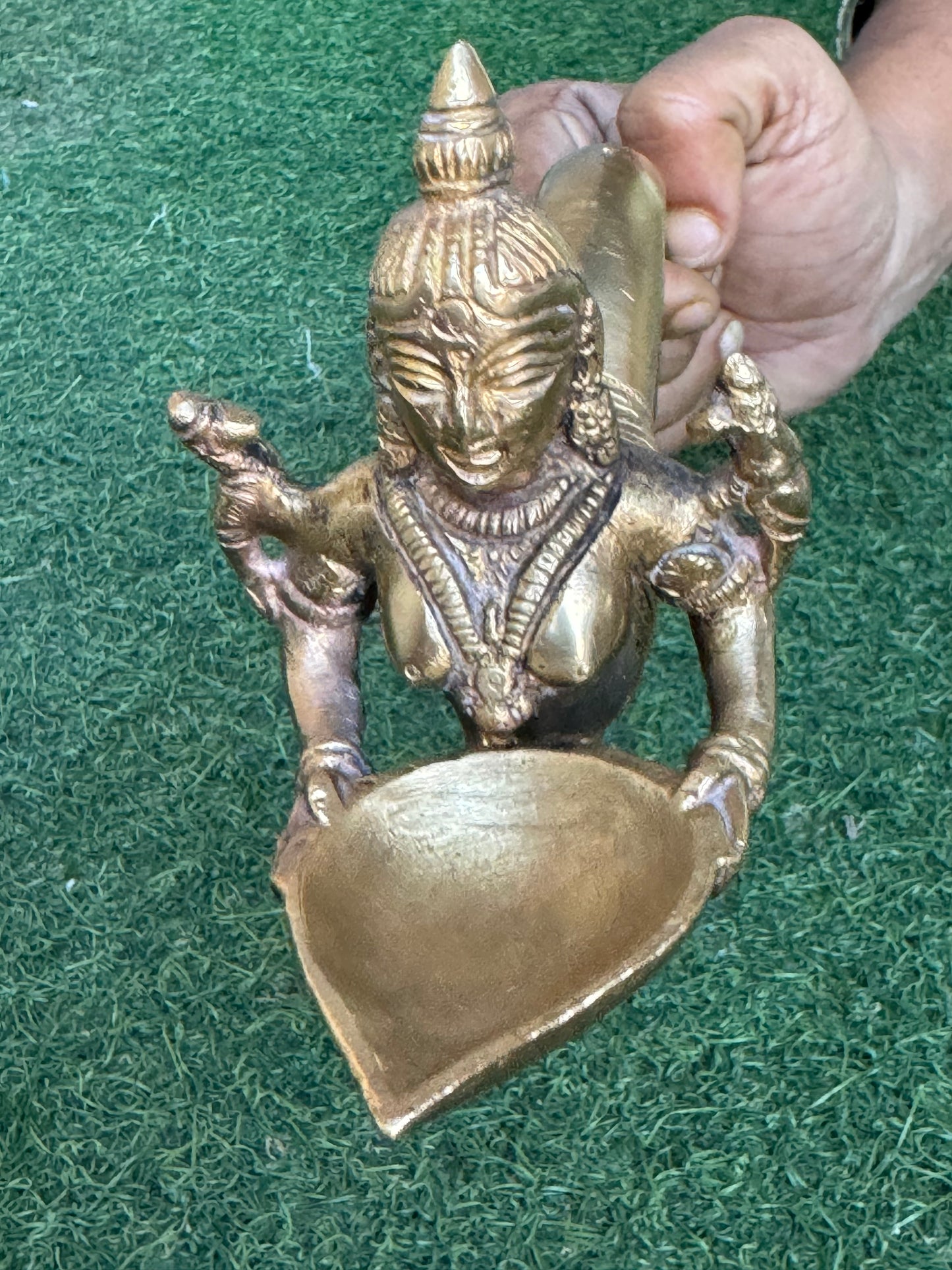 Lady holding Diya with long mermaid handle - handcrafted in brass