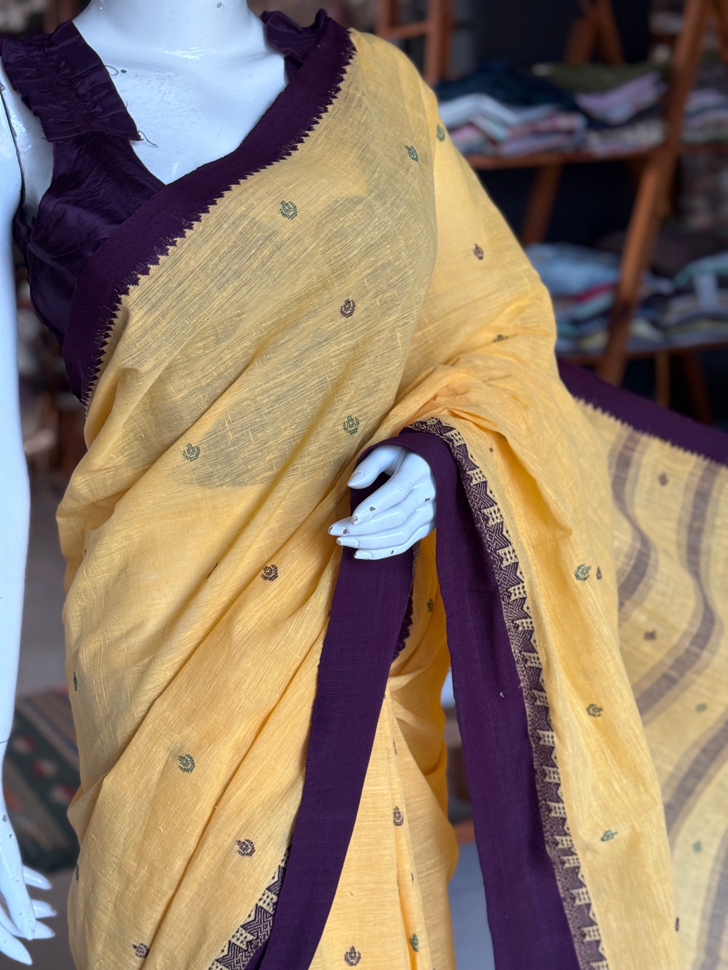 Yellow coarse textured handloom cotton saree with small butis and purple Kuppadam border