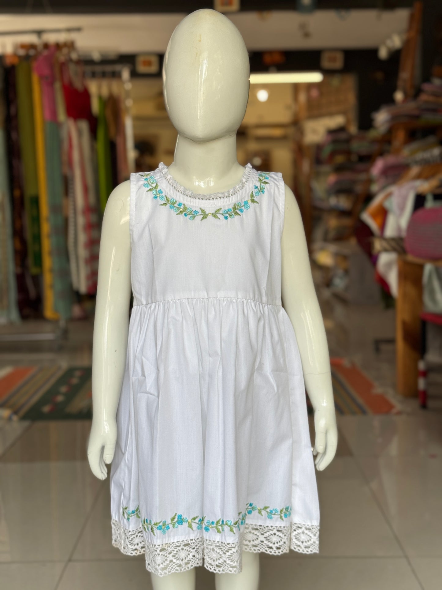 White floral embroidered cotton sleeveless frock with lace trims