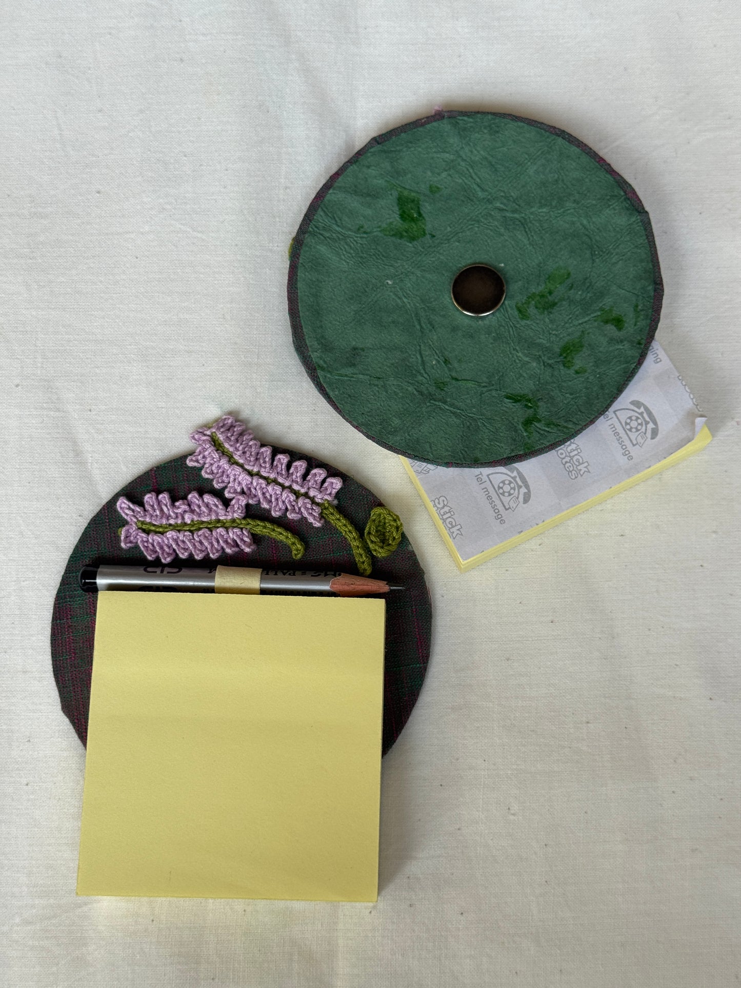 Round fridge magnet with crochet detailing to keep your shopping / to-do list handy