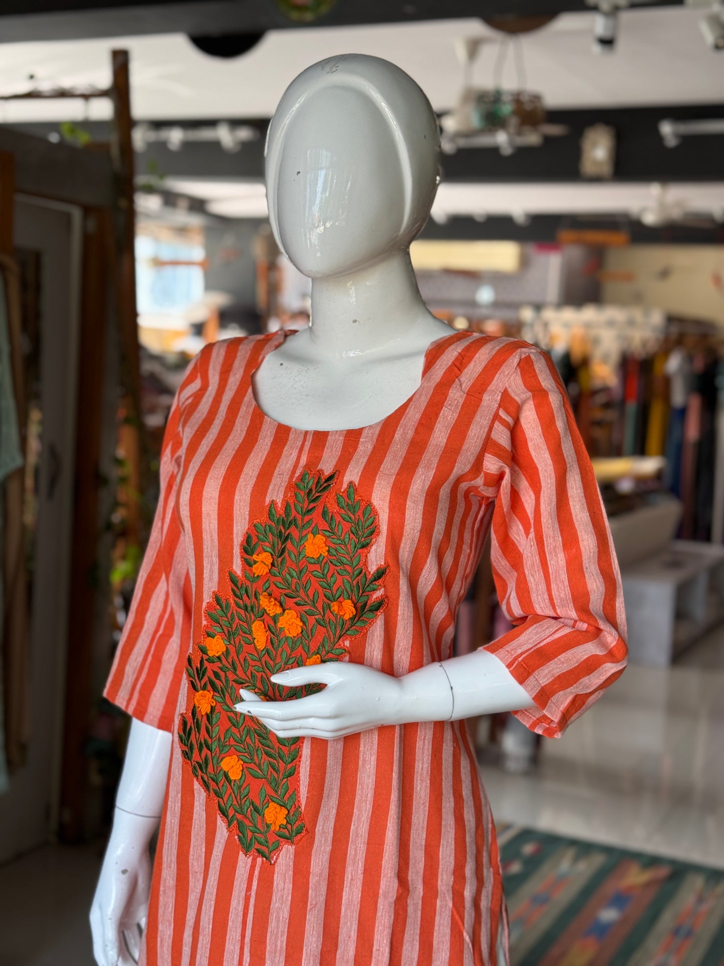 Bright orange stripes handwoven kala cotton straight kurti with leaves and flowers embroidery on the front