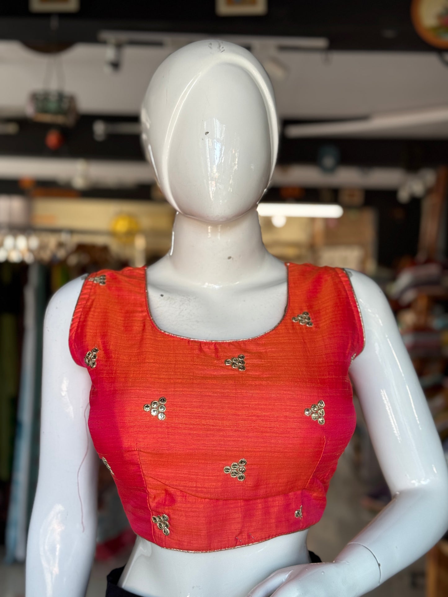 Orange embroidered sleeveless blouse with deep back
