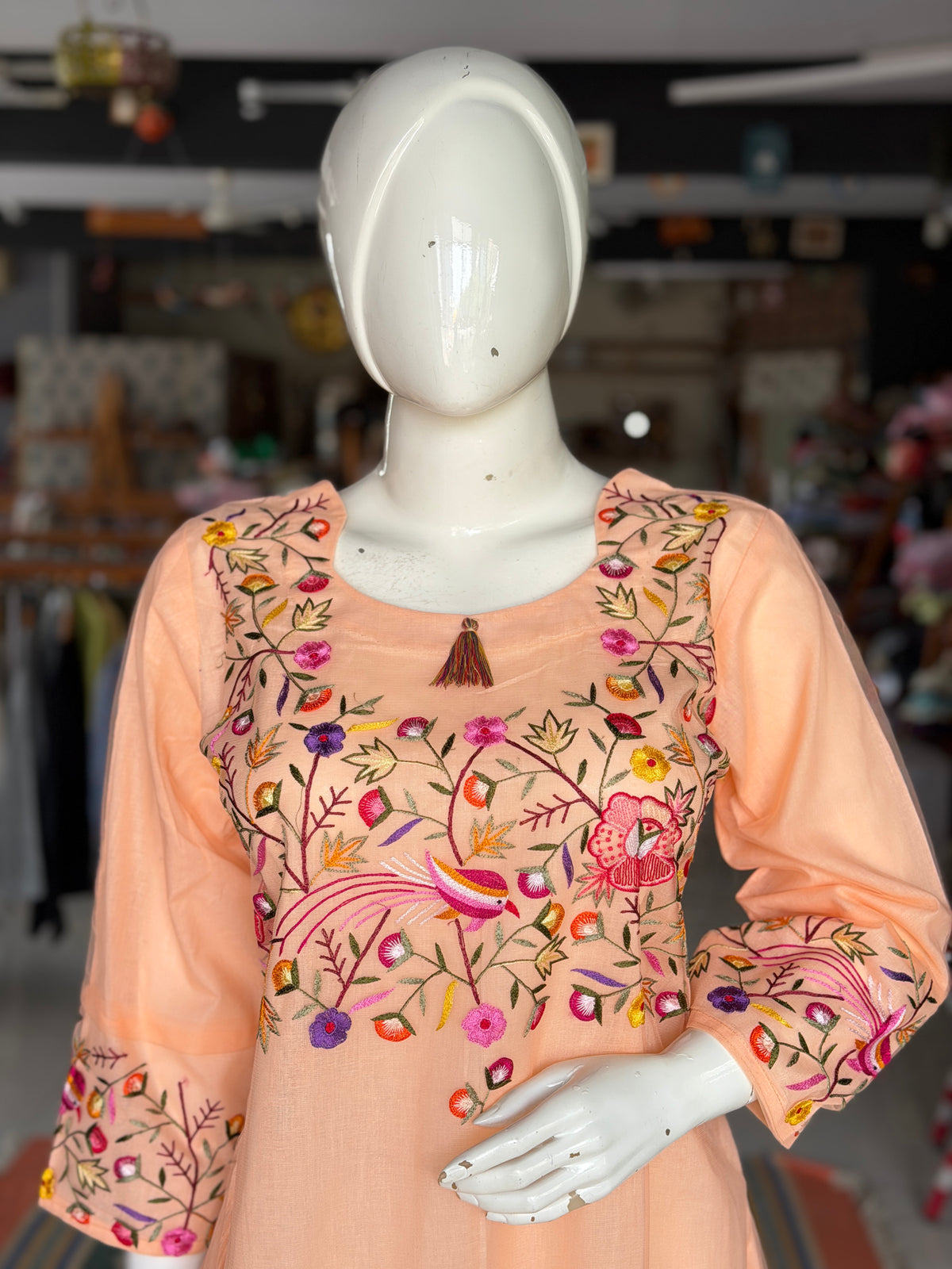 Peach hand embroidered birds and flowers design a-line net kurti with cotton lining