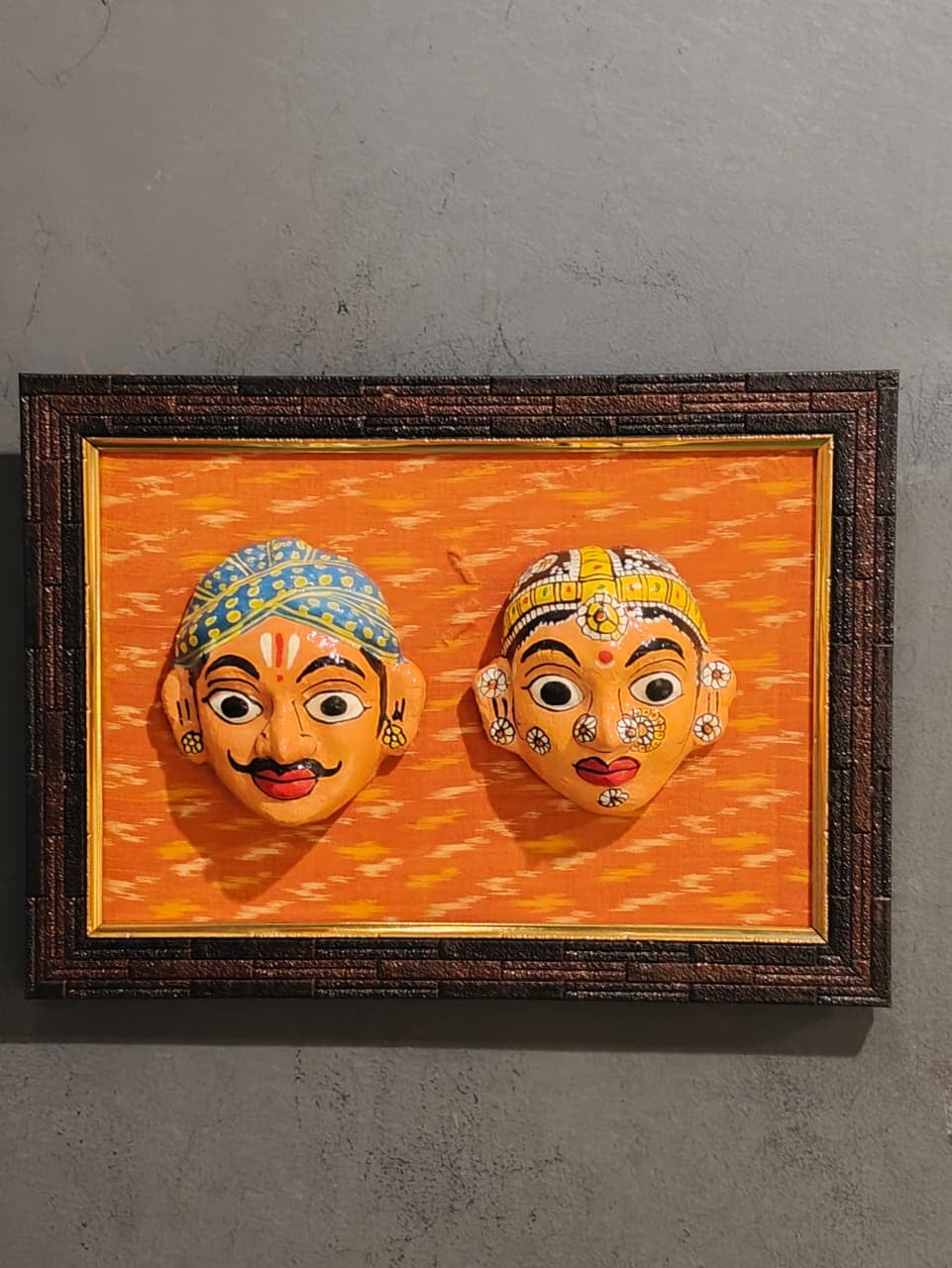 Cheriyal man and woman handcrafted masks pair on ikat background wall frame