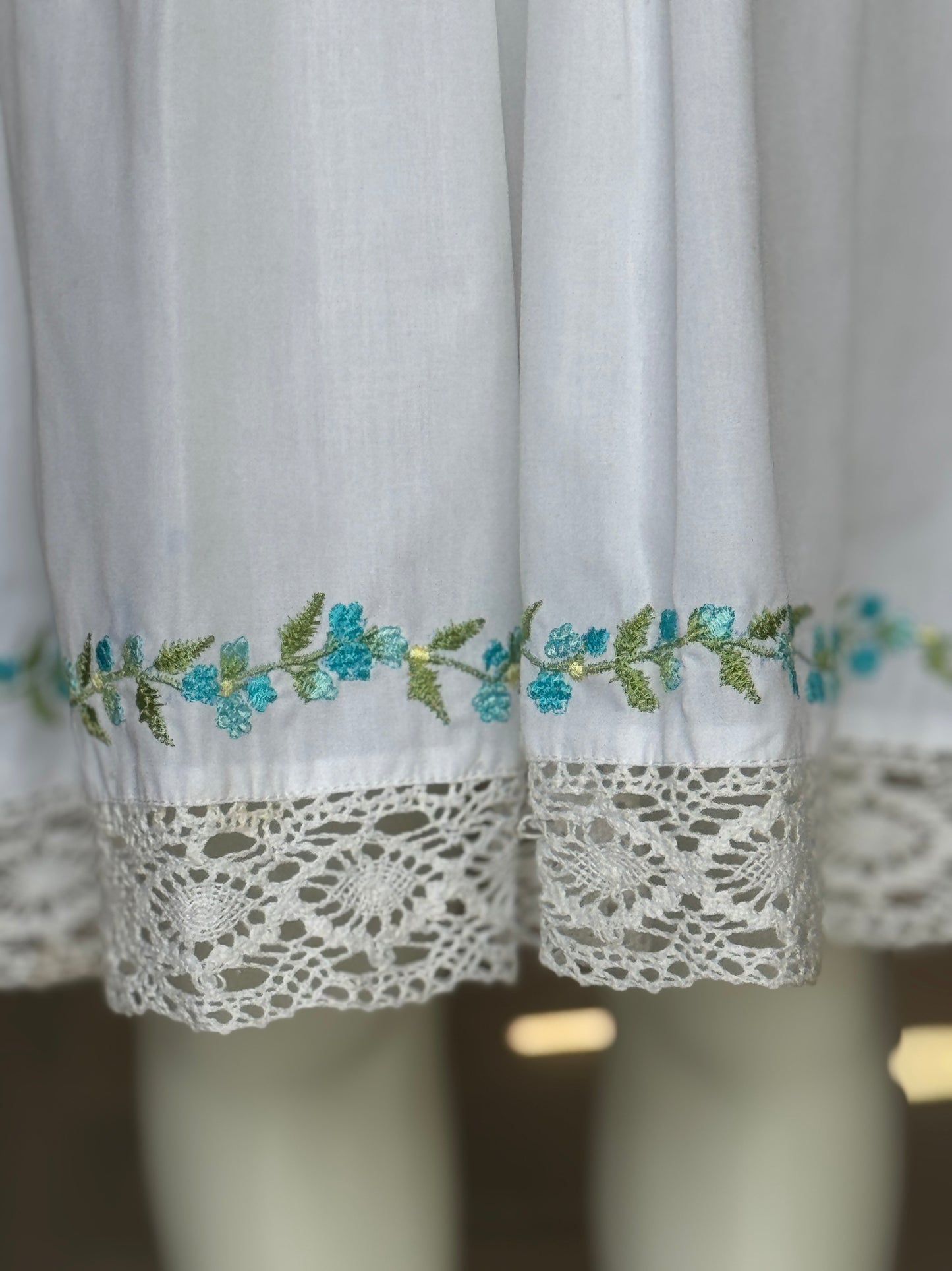 White floral embroidered cotton sleeveless frock with lace trims