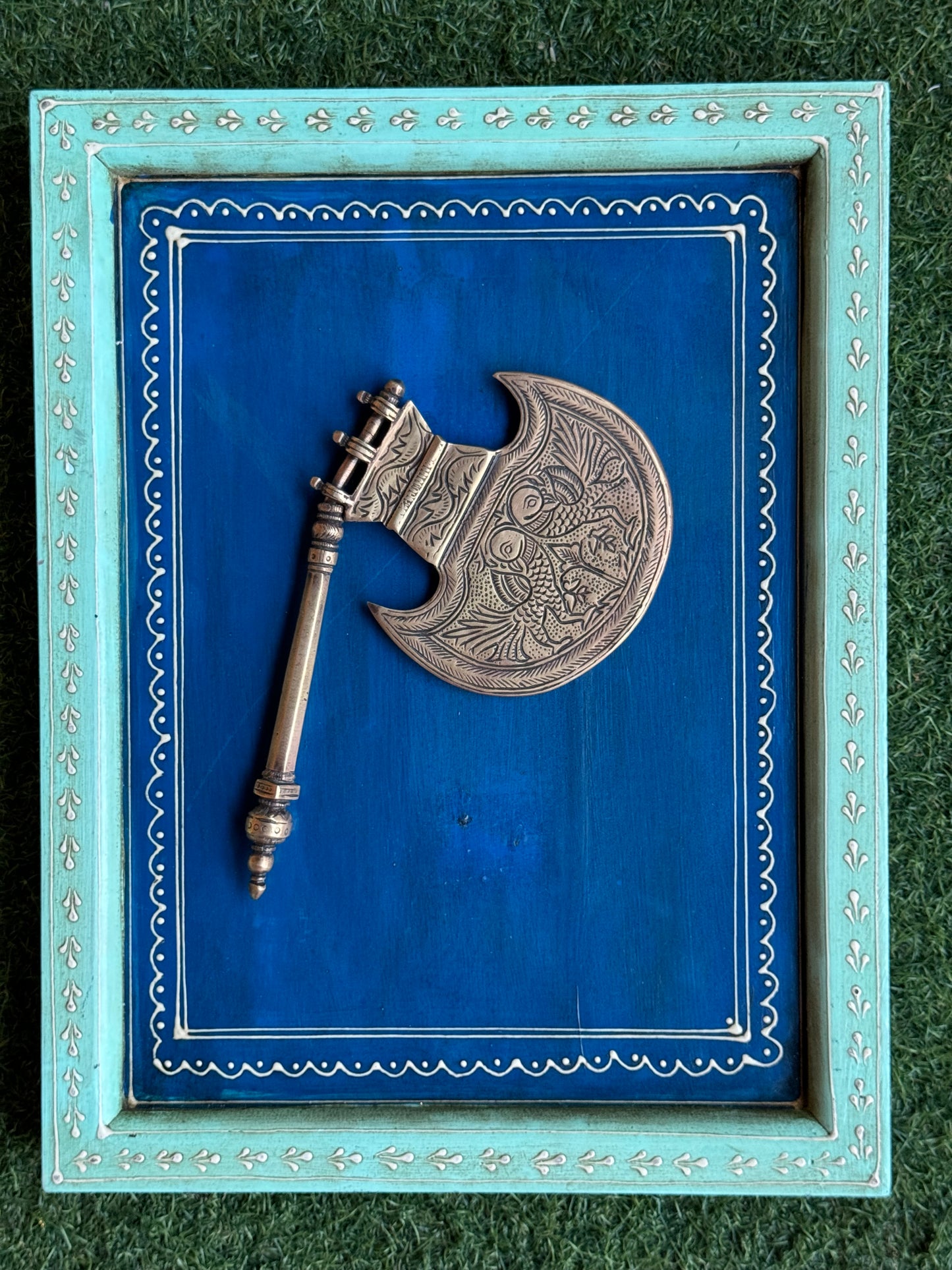 Vintage brass decorative fan with different engraved designs on both sides