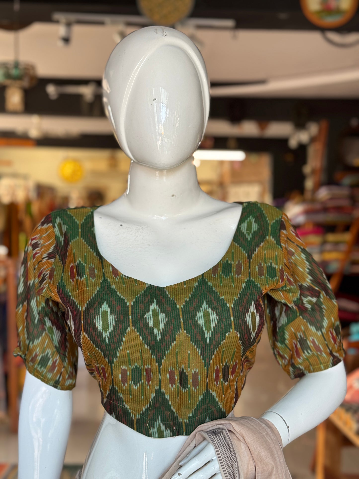 Dark green Ikat cotton blouse with curved waist line