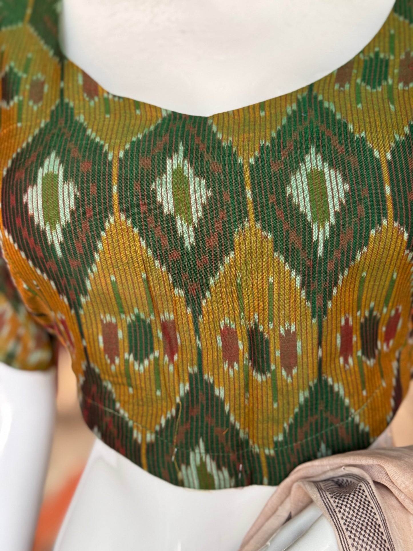 Dark green Ikat cotton blouse with curved waist line