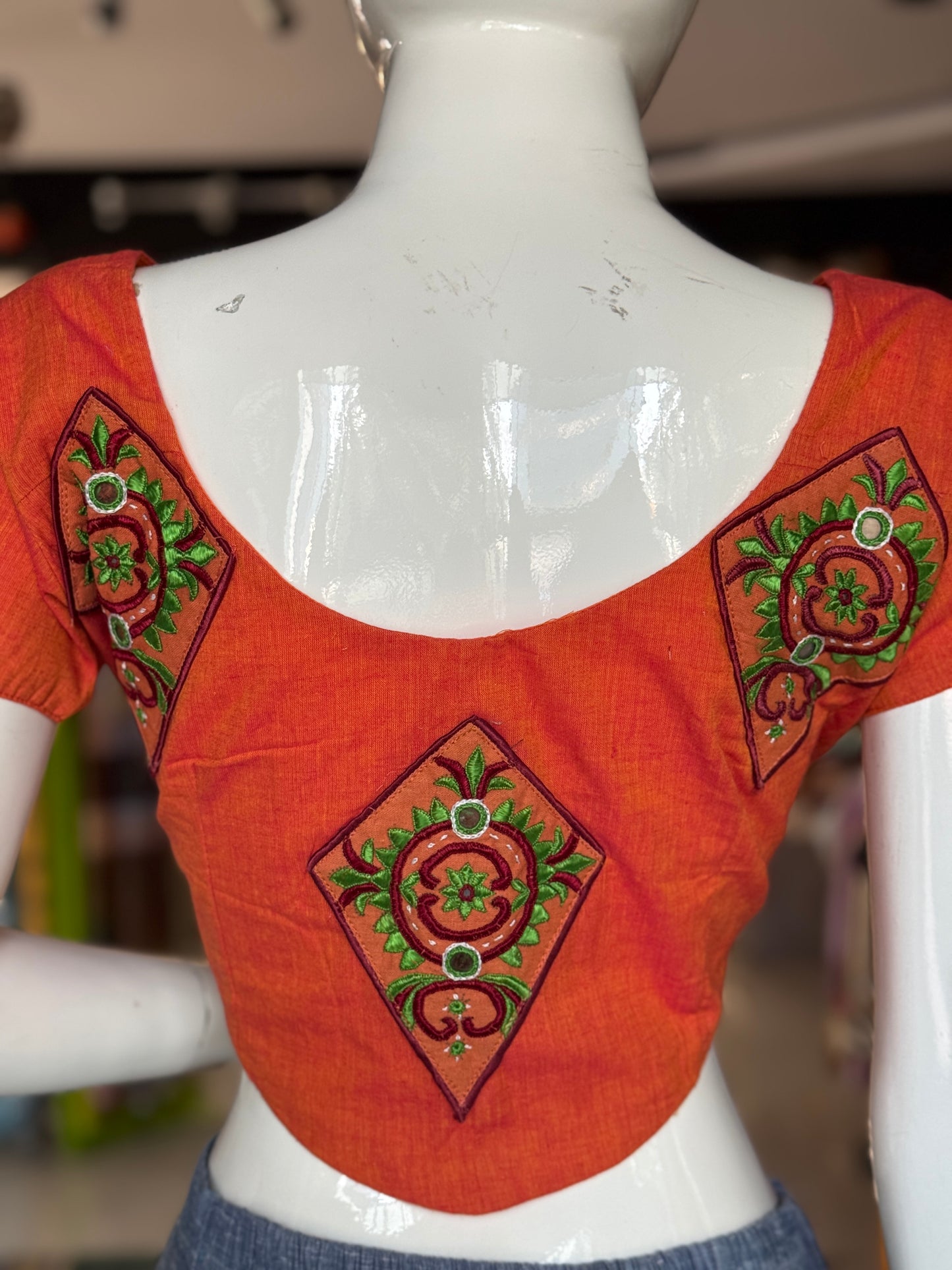 Orange cotton blouse with  embroidered patches on the back and sleeves