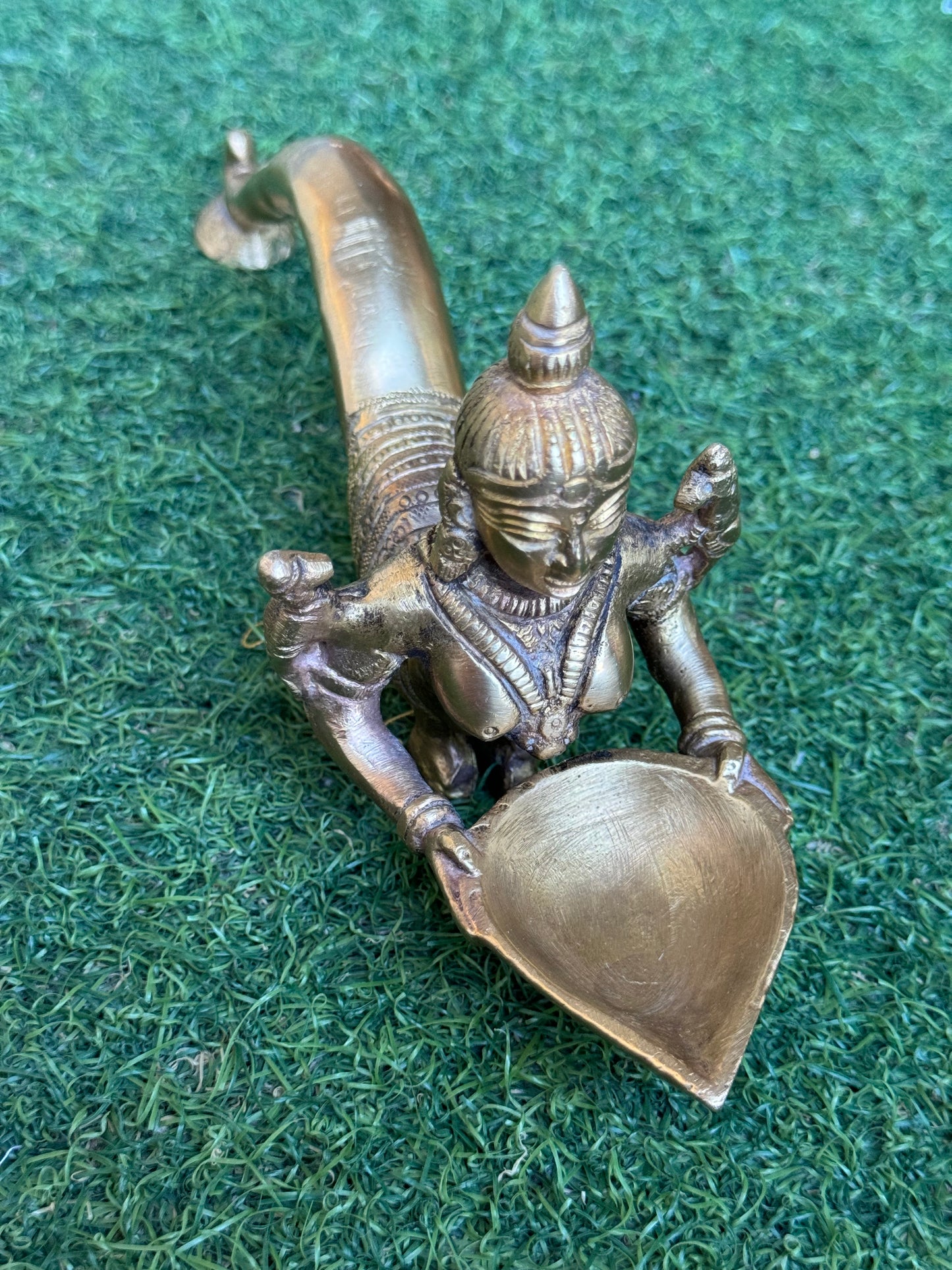 Lady holding Diya with long mermaid handle - handcrafted in brass