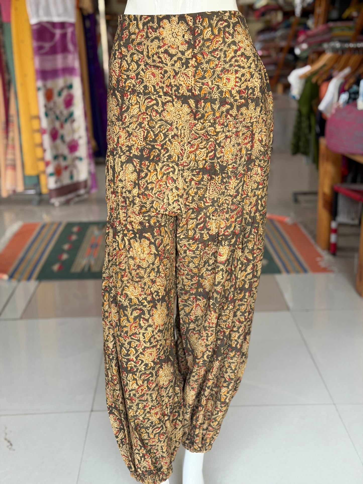 Olive green Kalamkari hand block printed cotton harem pants for women with elastic hem