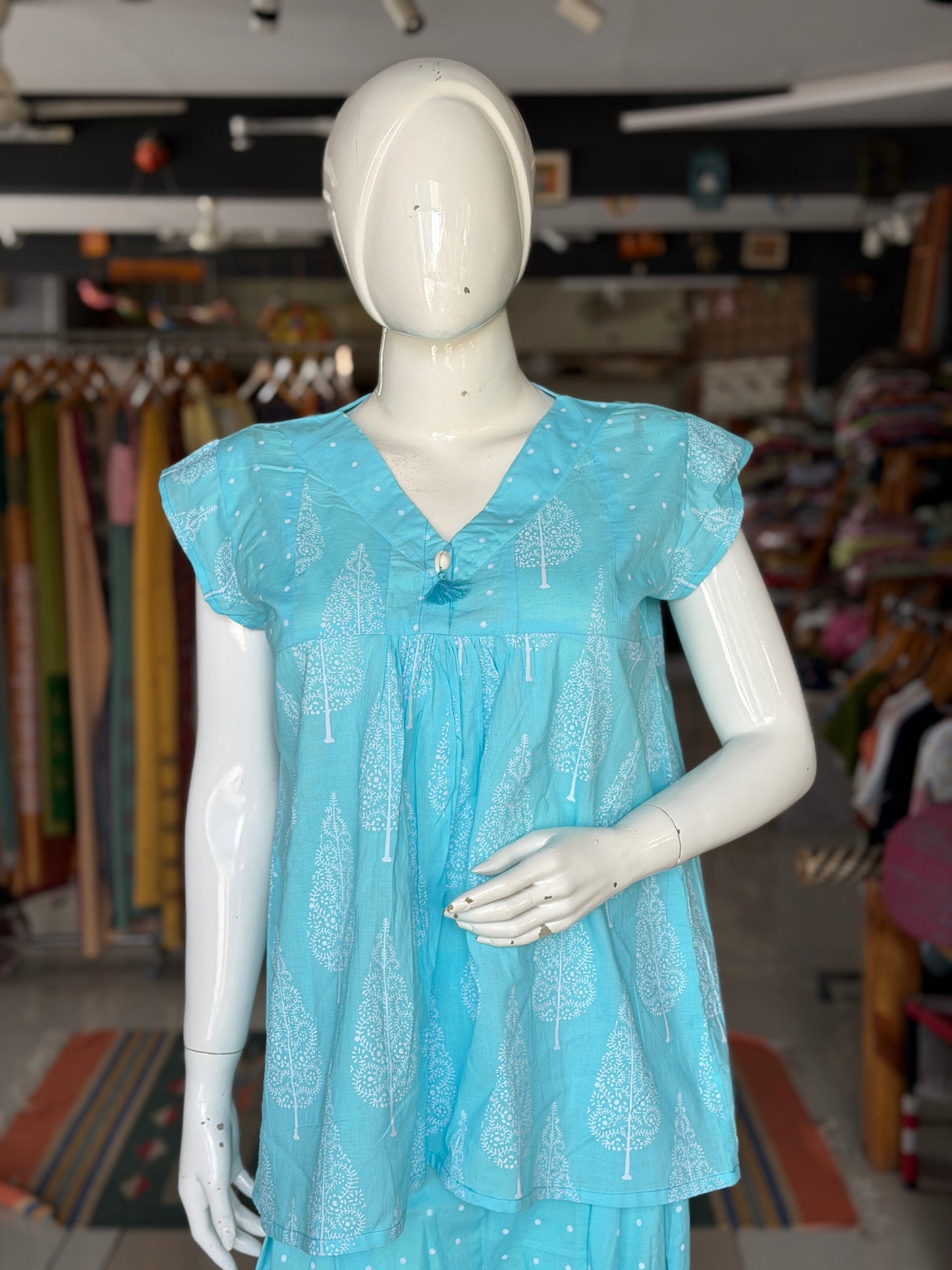 Blue dots and cypress print pleated cotton top with cowrie shell button