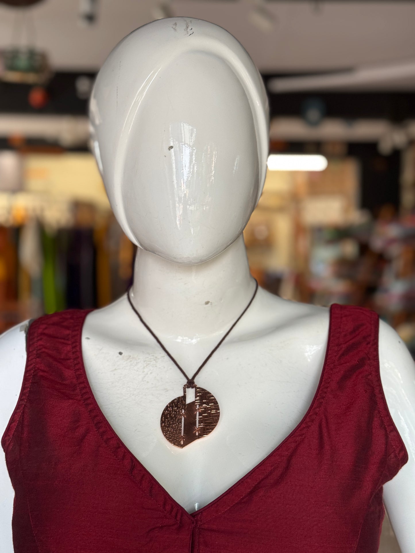 Handcrafted copper pendant with brown thread neck piece