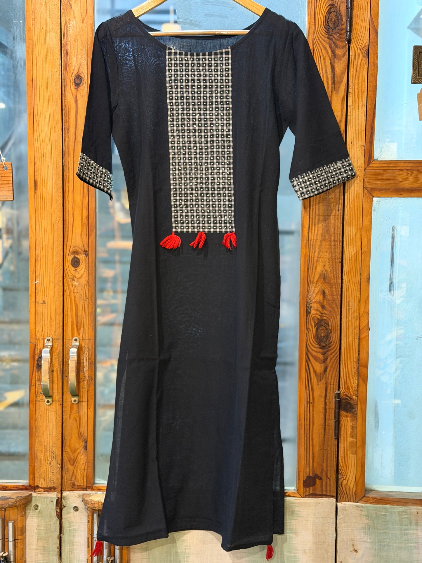 Black cotton straight kurti with white French knot embroidery on the front