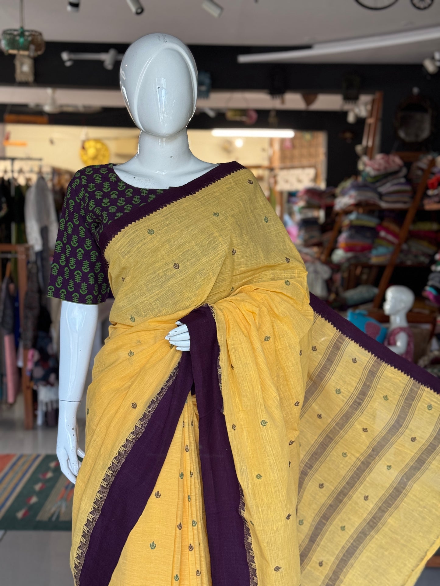 Yellow coarse textured handloom cotton saree with small butis and purple Kuppadam border