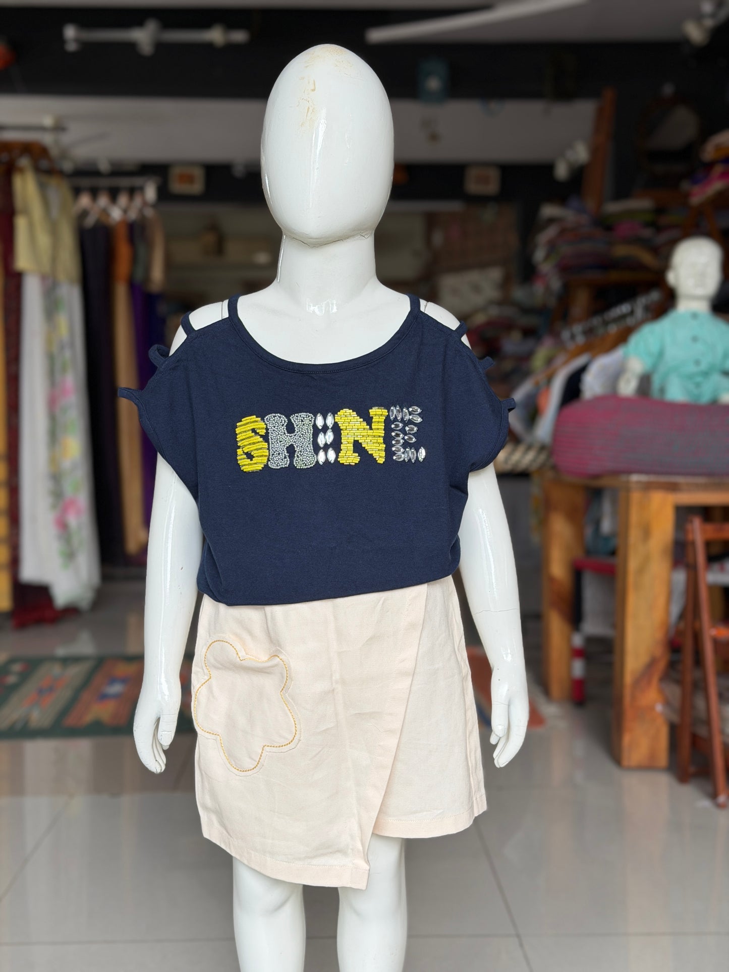 Navy blue “shine” t-shirt top with embroidered letters and strappy sleeves and shoulder