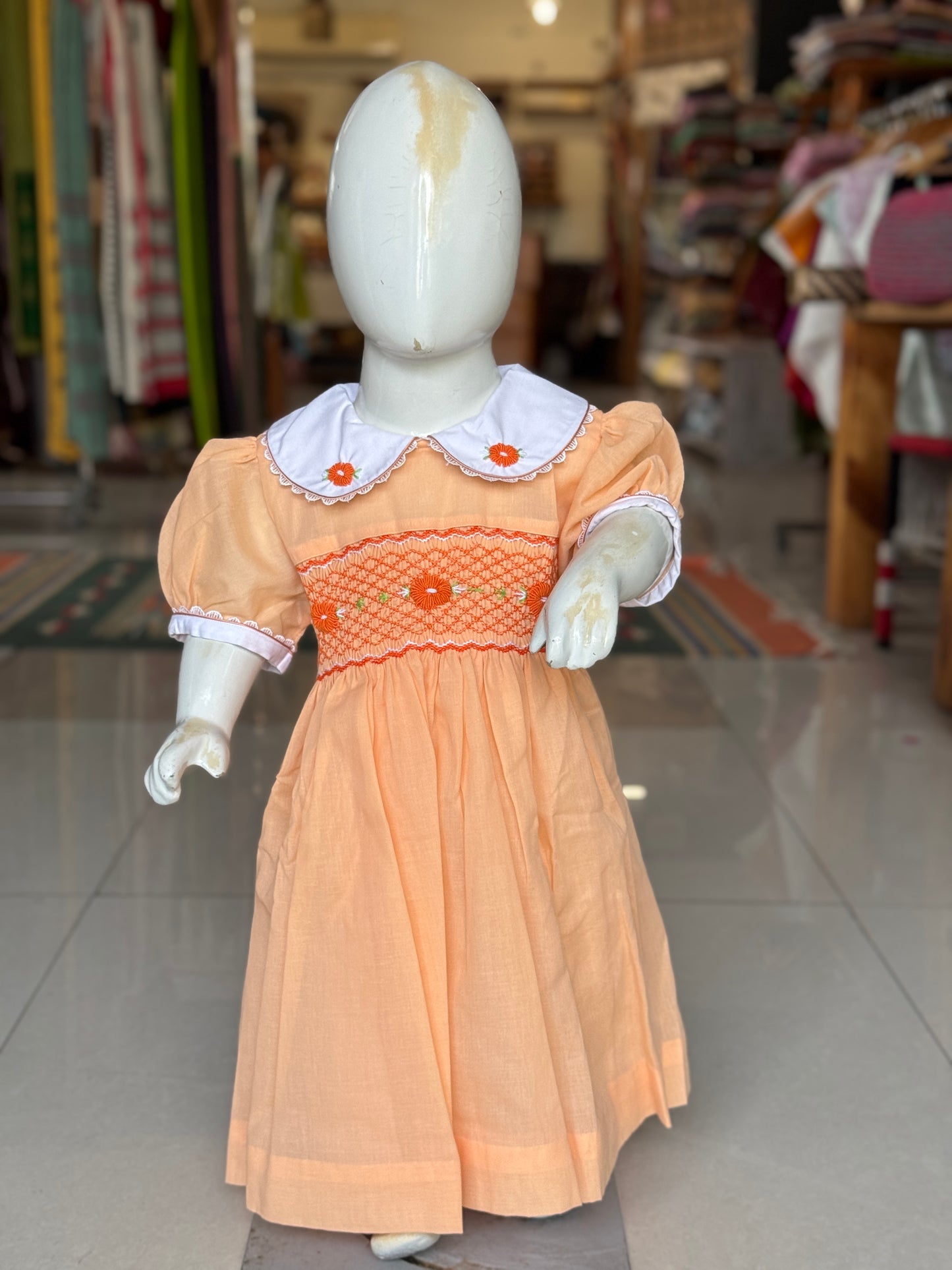 Peach hand embroidered smocking cotton frock for girls with collar